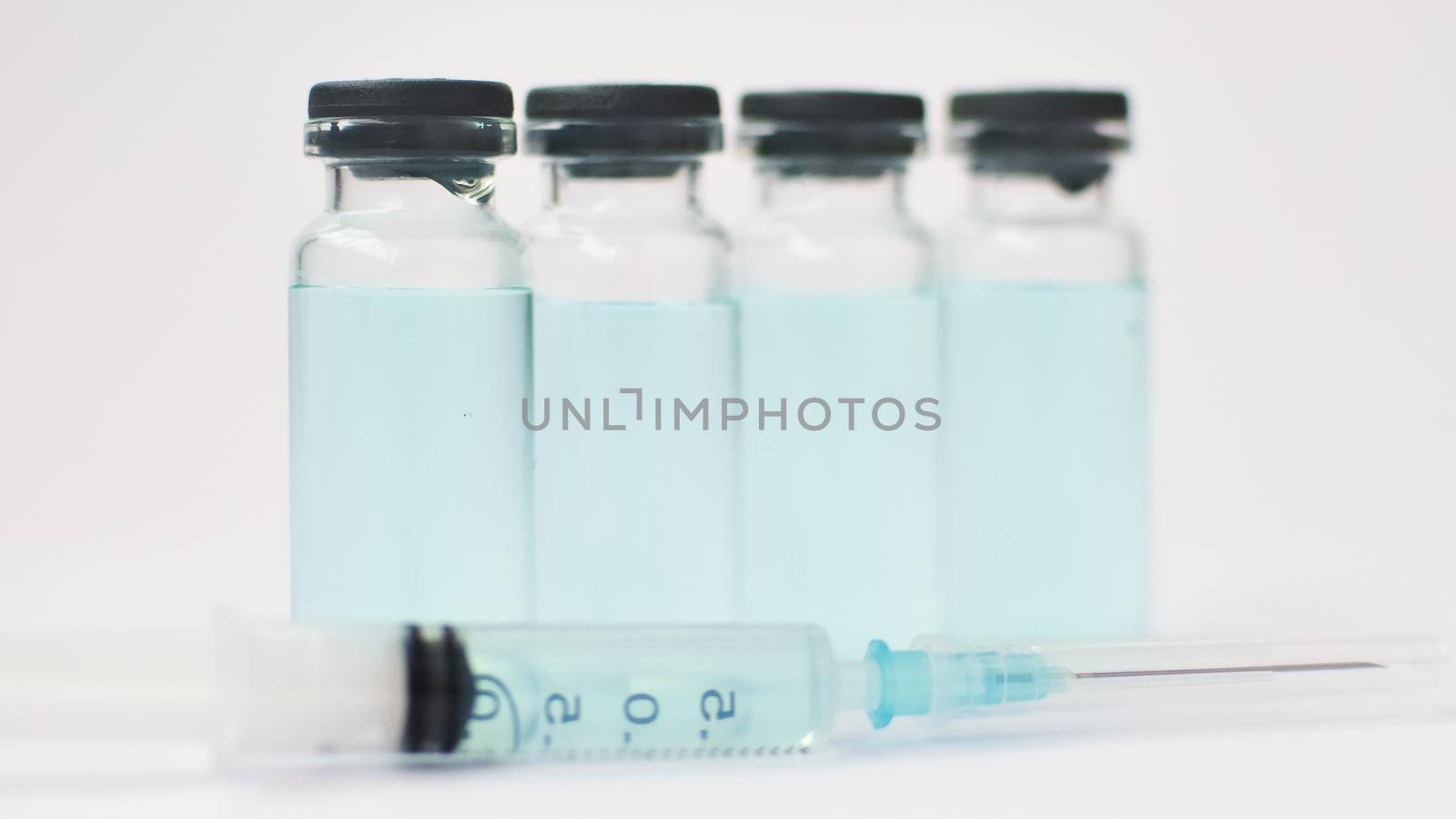 Medical ampoules and insulin syringe isolated on white background, vaccination concept.