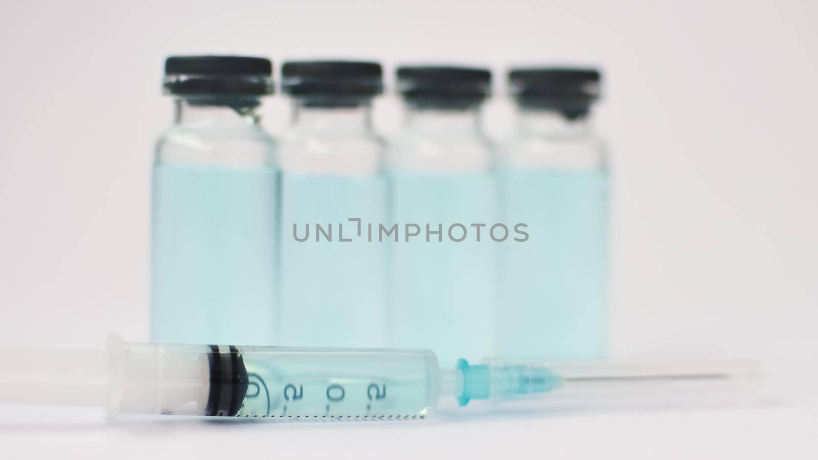 Medical ampoules and insulin syringe isolated on white background, vaccination concept.