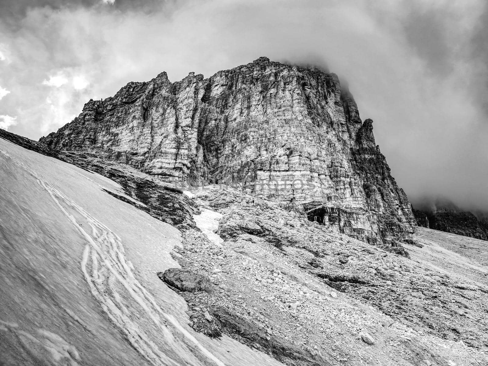 Tre Cime di Lavaredo rocks  hidden in gentle fog. Early summer trip in Dolomites in Italy. BW, Black and white,