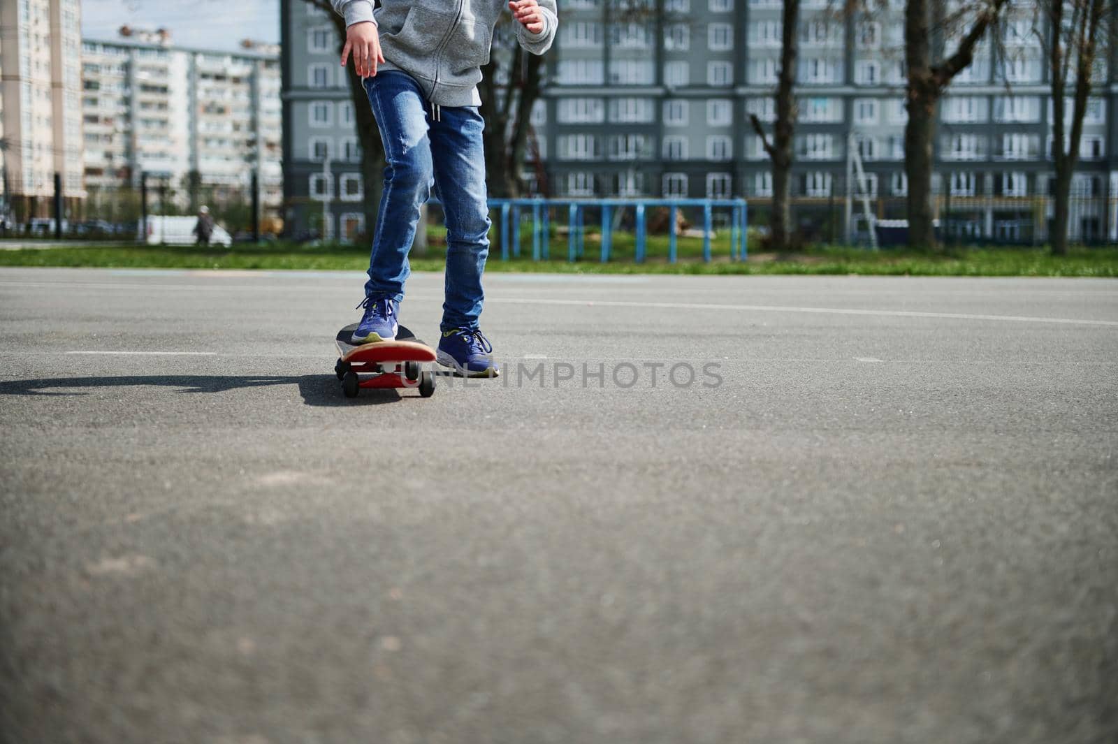 Partial view of an unrecognizable boy riding skateboard outdoors. Concept of leisure activity, sport, extreme, hobby and motion.