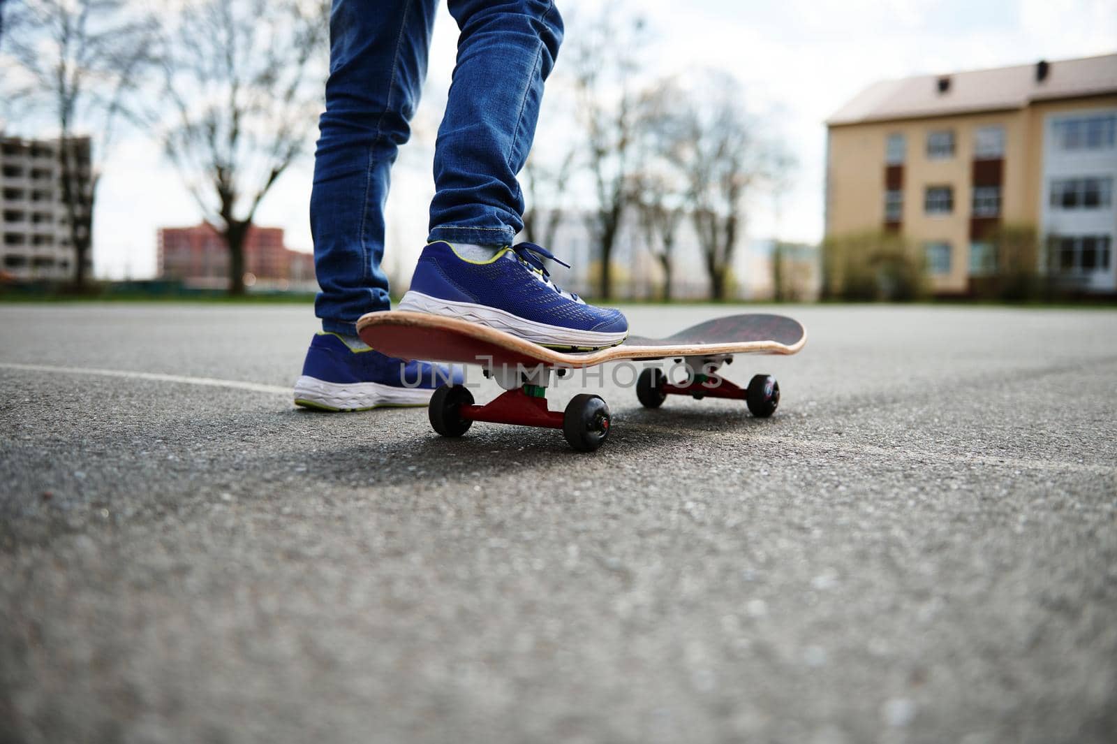 Closeup of skateboarder legs. Kid riding skateboard outdoor. Concept of leisure activity, sport, extreme, hobby and motion.