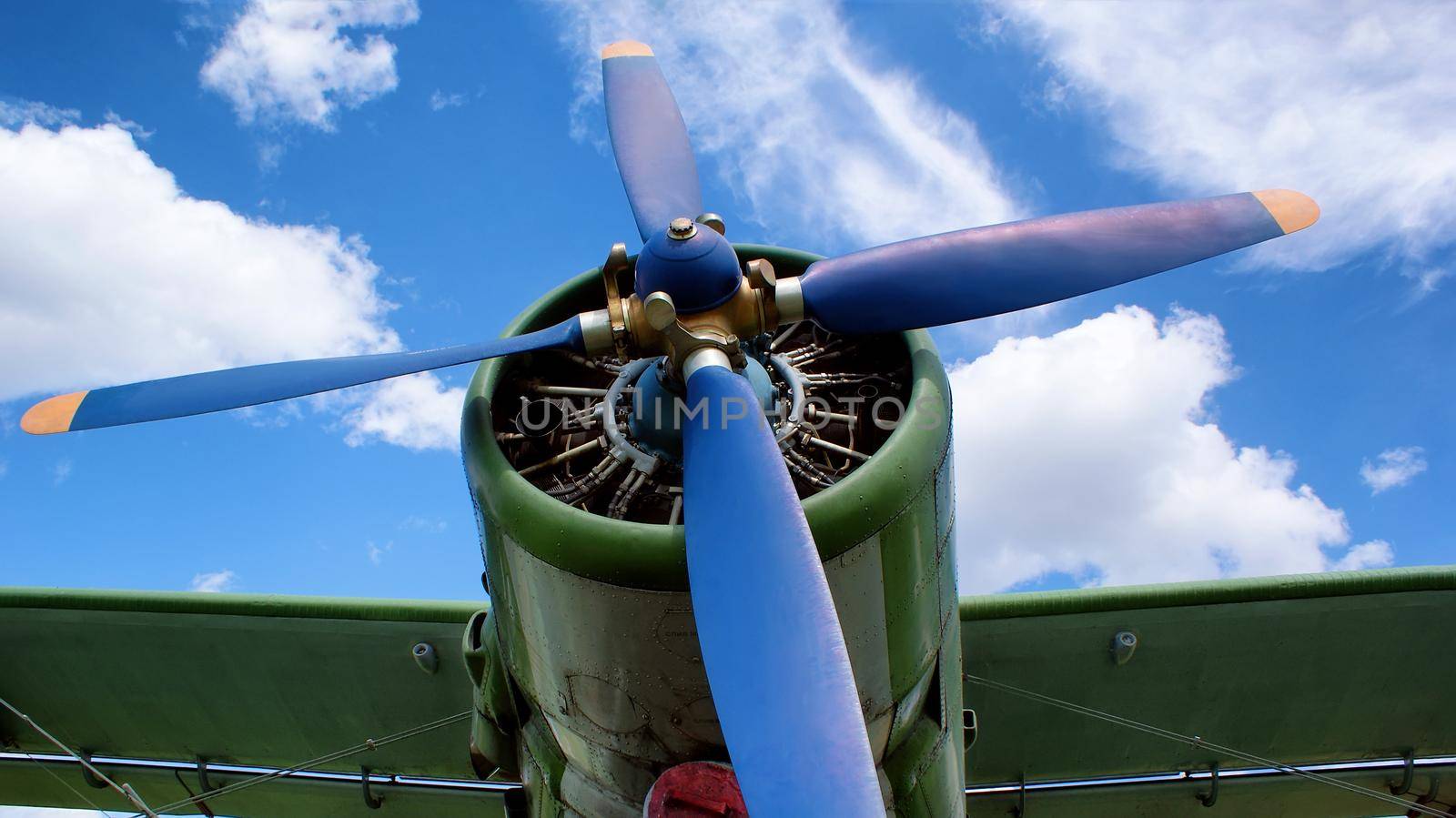 The engine of the screw plane of an old aircraft. Blades of blue retro style.