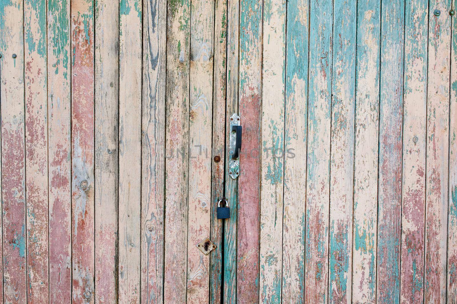 Fragment of the old and dilapidated doors. Wooden vertical texture of turquoise Colors, shabby wooden surface. Old texture for antique background Old texture for antique background