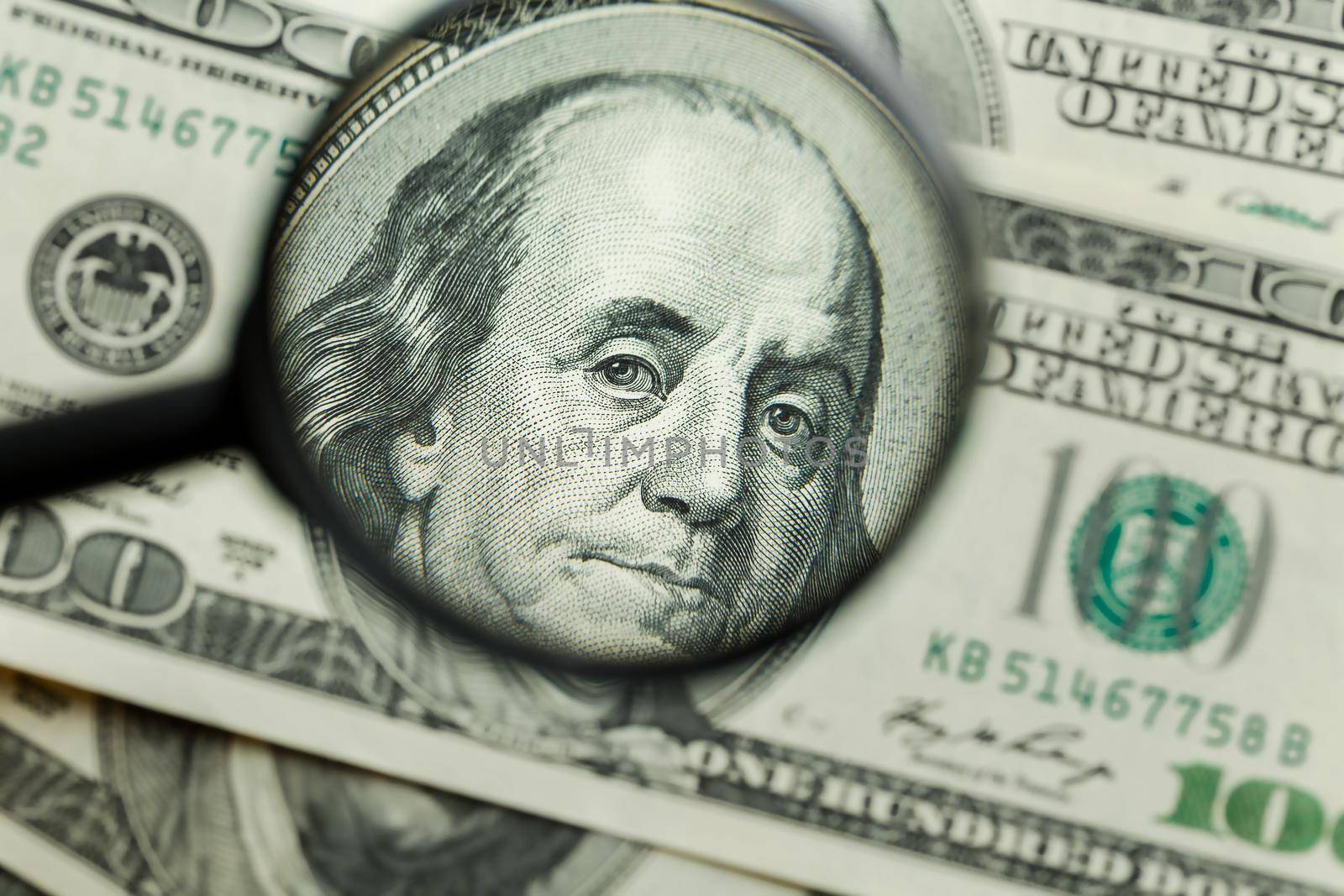 Magnifying glass on money background, business concept
