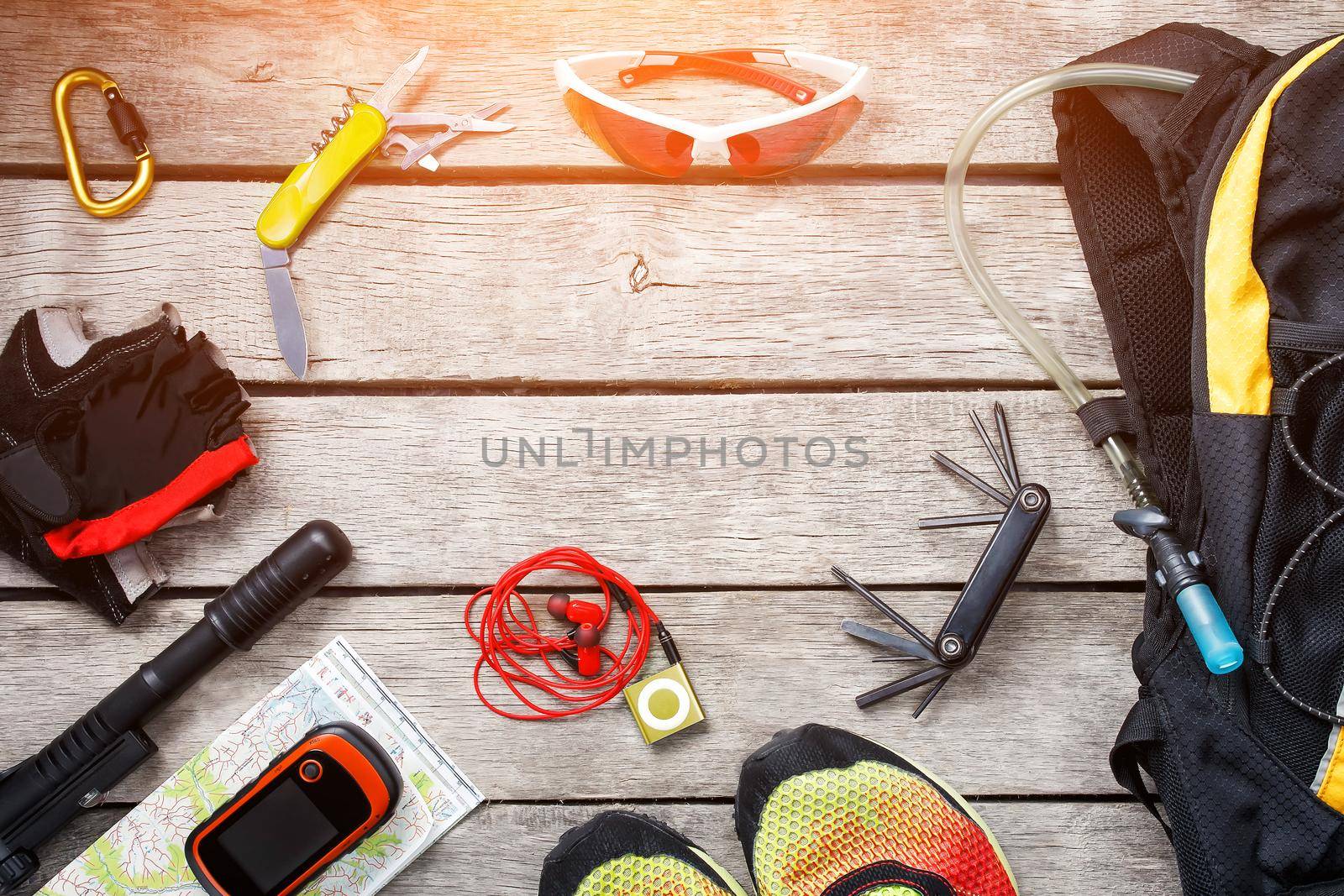 Set of things and tourist equipment for travel and adventure on a gray wooden background. Top view set by AlexGrec