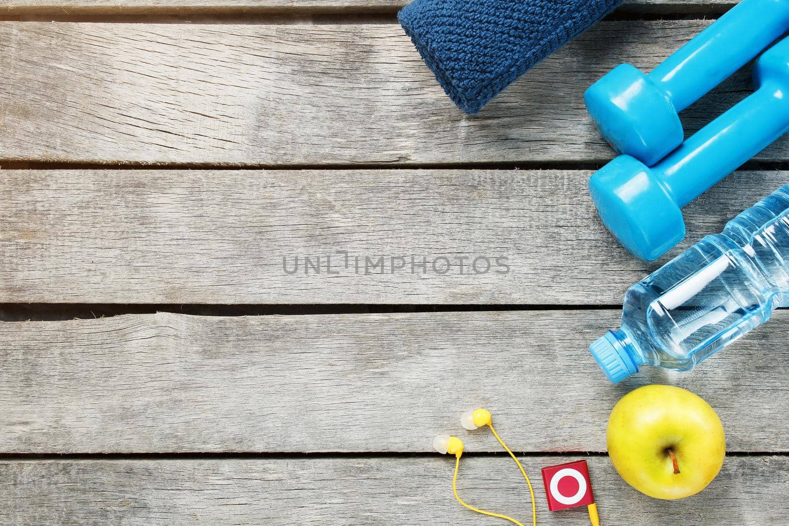 Set of sports accessories for fitness concept with exercise equipment on gray background. Background view from above