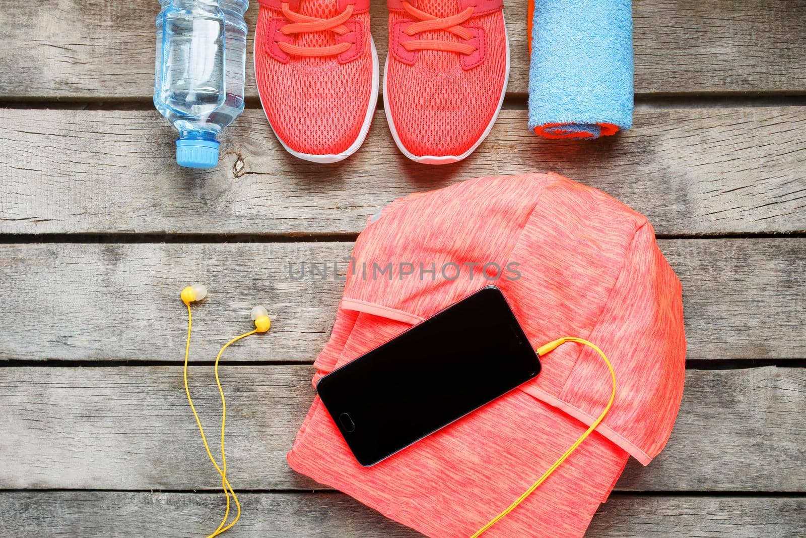 Set of sports accessories for fitness concept with exercise equipment on gray wooden background. by AlexGrec