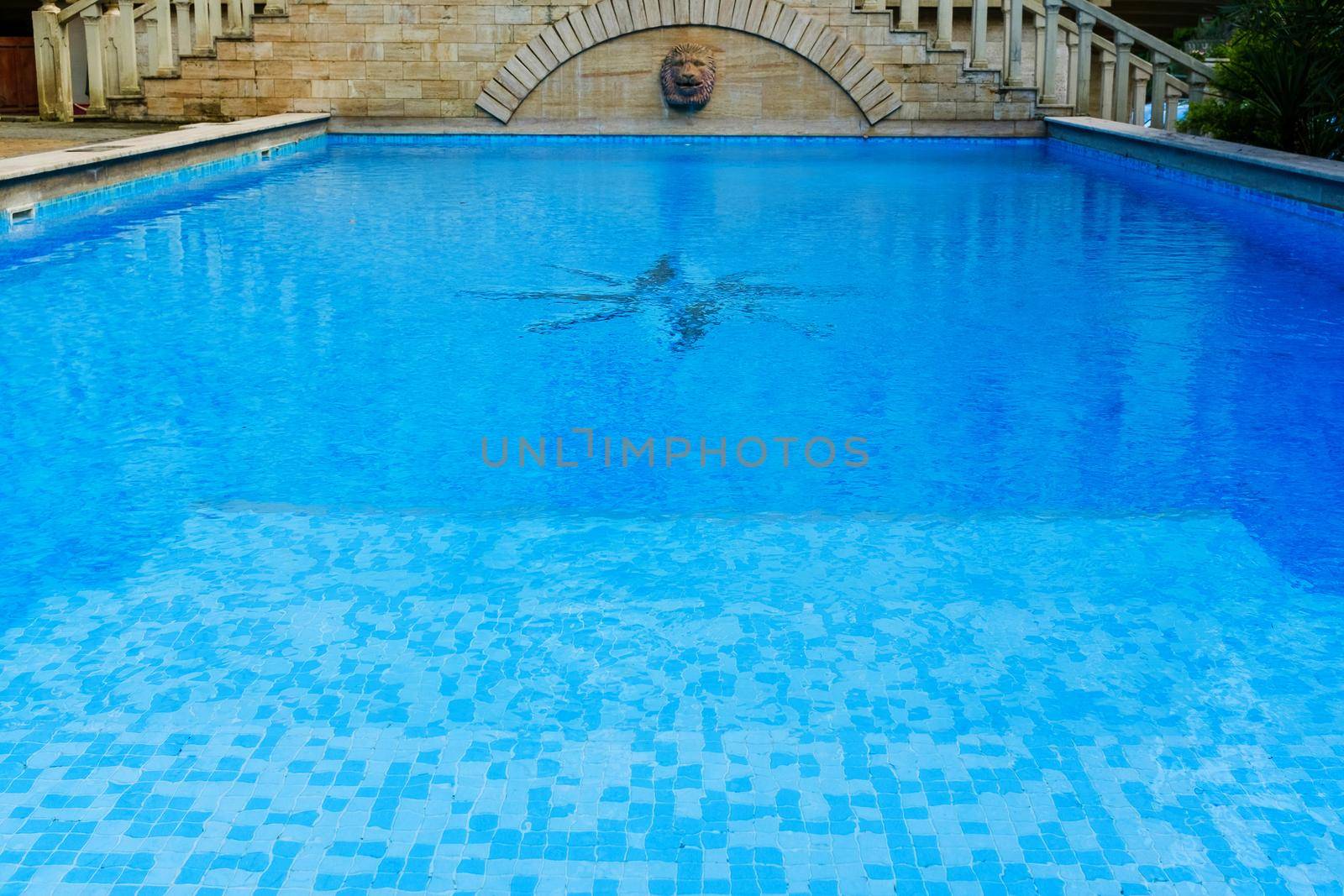 surface of blue swimming pool,background of water in swimming pool. by AlexGrec