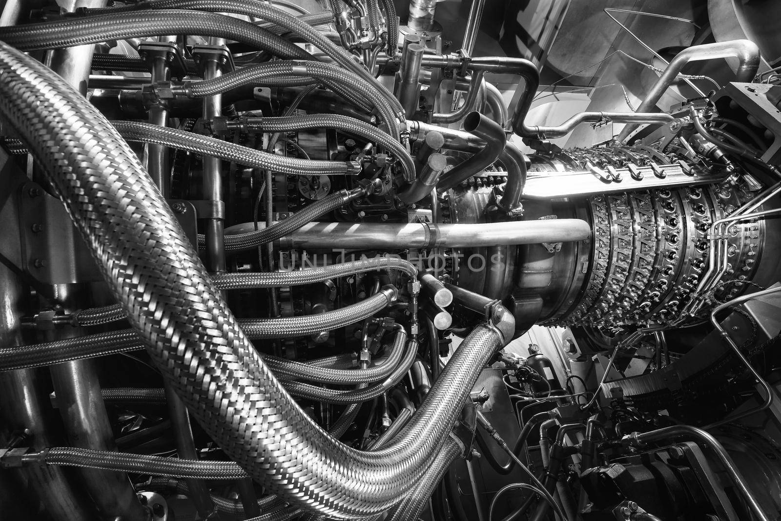 Gas turbine engine located inside the aircraft. Clean energy in a power plant used on an offshore oil and gas refining central platform. Oil gas, ecology and clean energy concept. Power and takeoff. Black and white frame