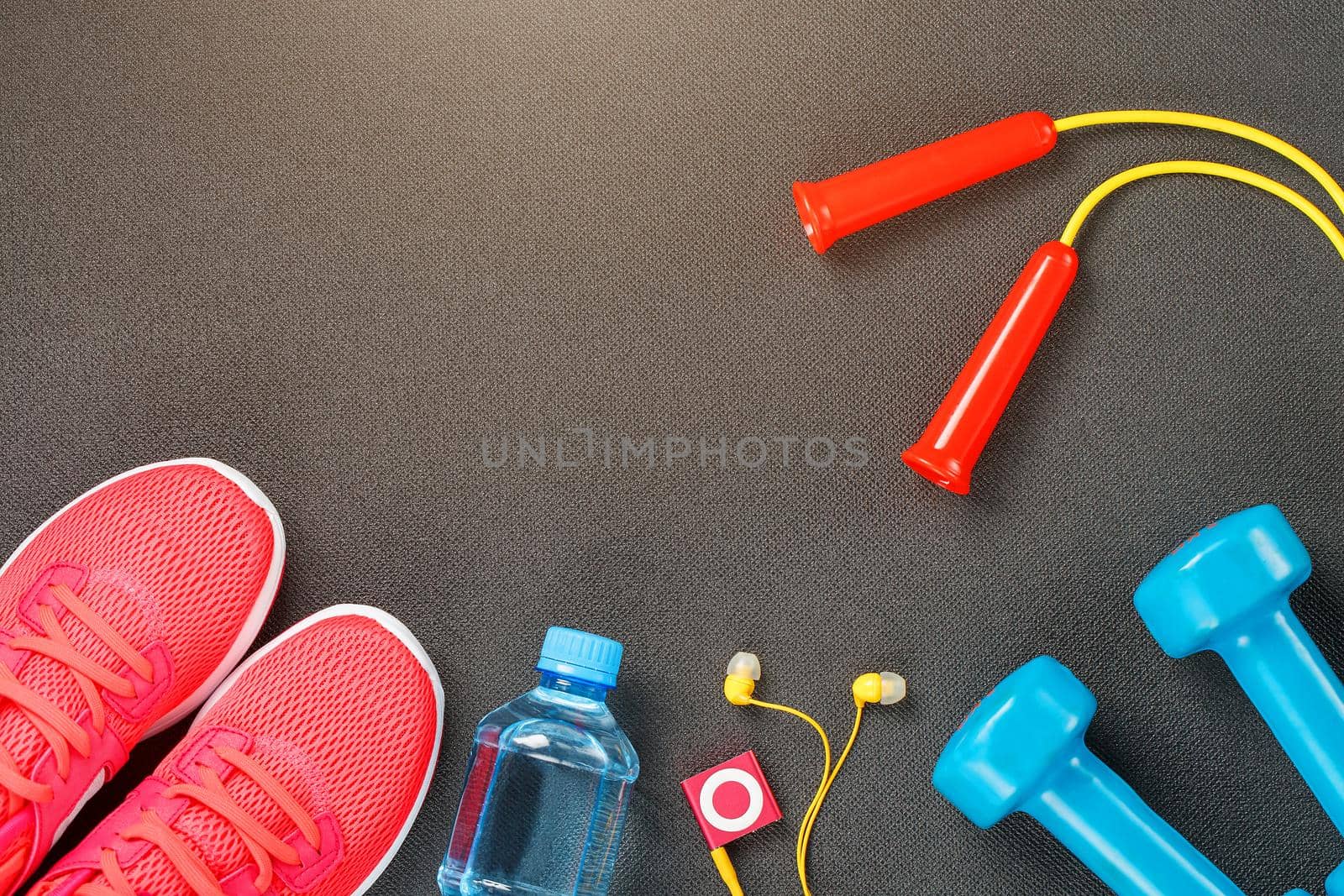 Set of sports accessories for fitness concept with exercise equipment on gray background by AlexGrec