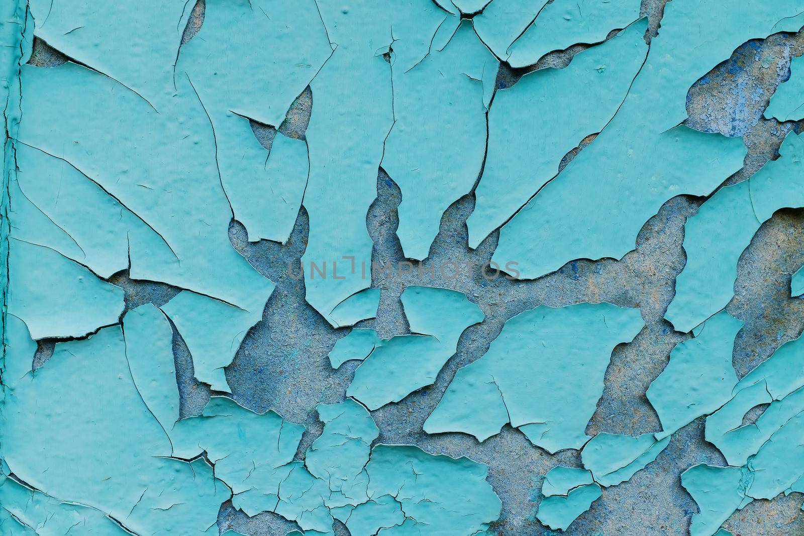 background consisting of old blue green door with peeling paint.