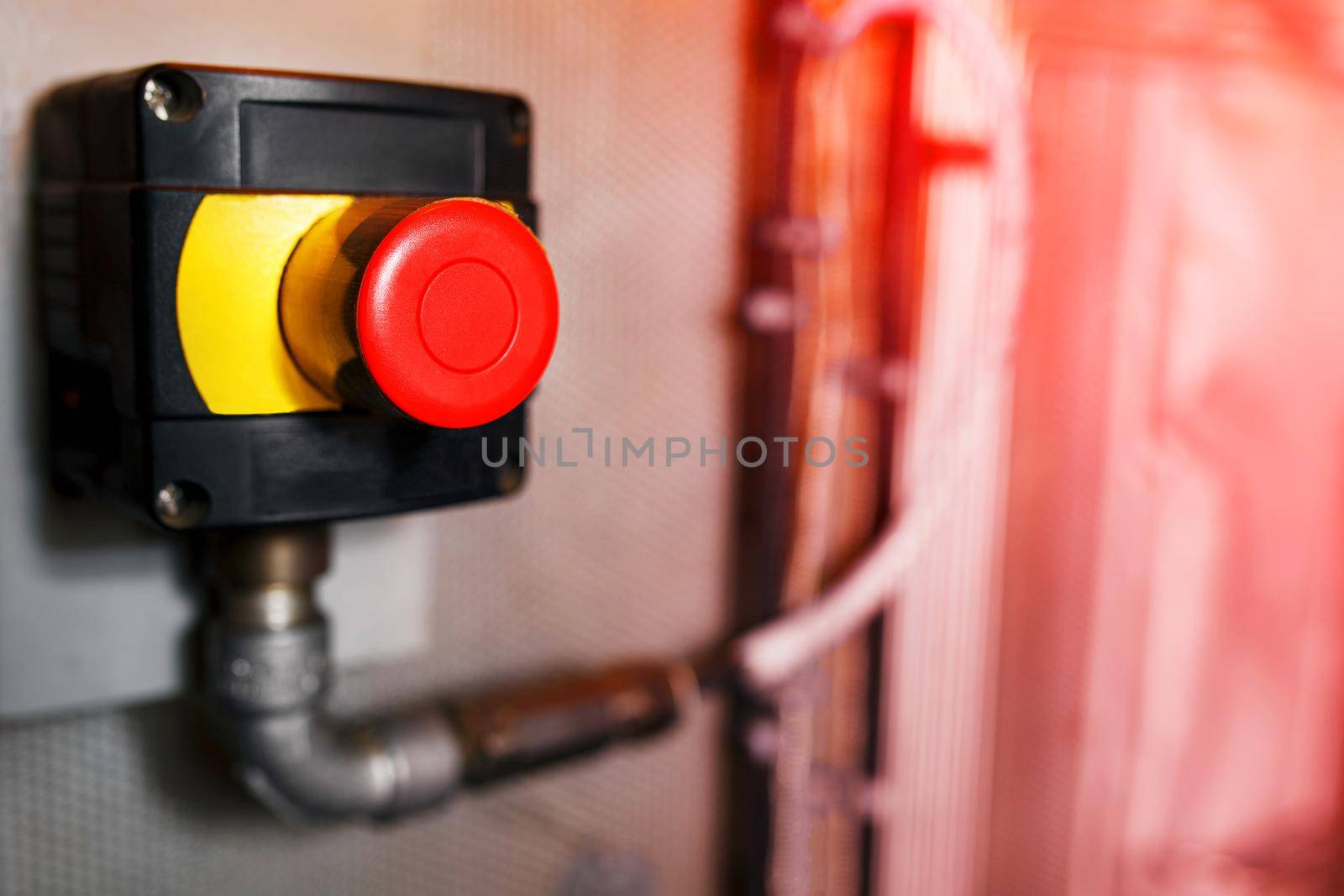 Big Red emergency button or stop button for manual pressing. STOP button for industrial equipment, emergency stop. Red light. At the factory and industrial facility. Concept