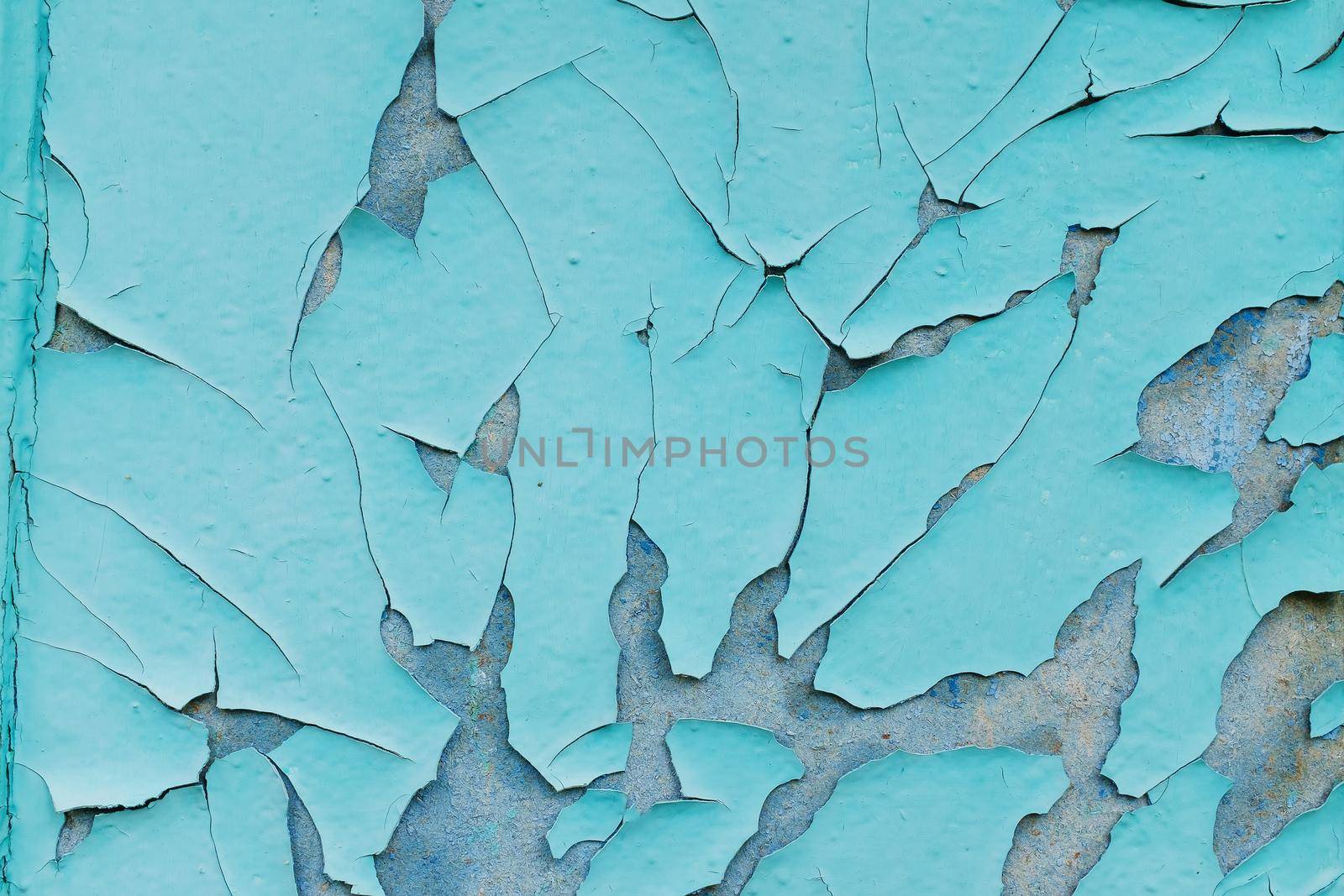 background consisting of old blue green door with peeling paint.