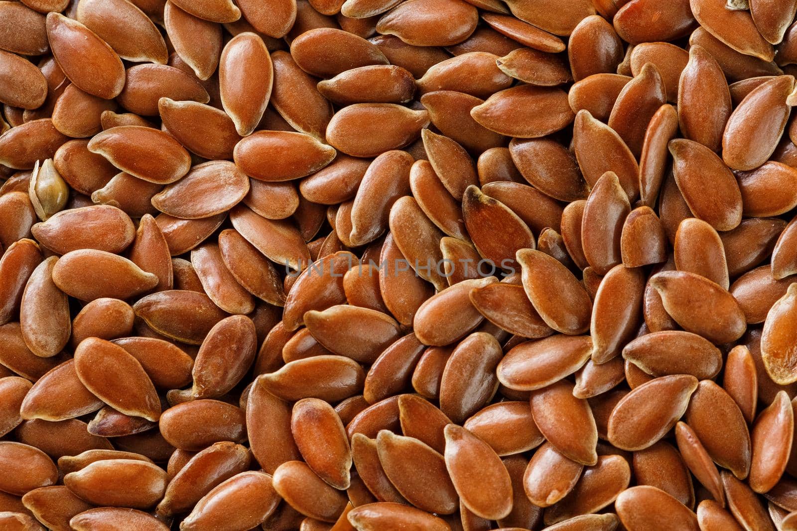 Background texture of seeds of dark brown flax. by AlexGrec