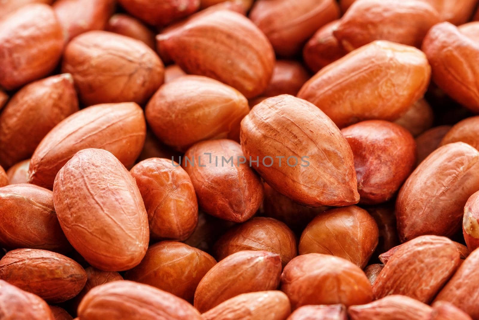Peanuts, for background or textures, uncleaned inshell peanuts. Peeled peanut on well peanuts