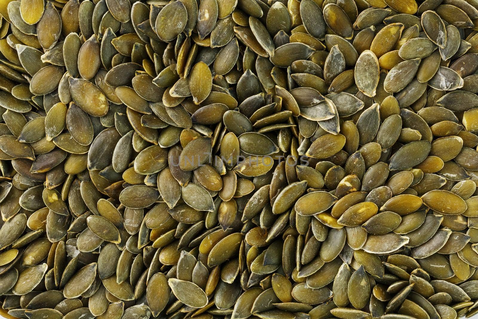 Macro background texture of green pumpkin seeds by AlexGrec