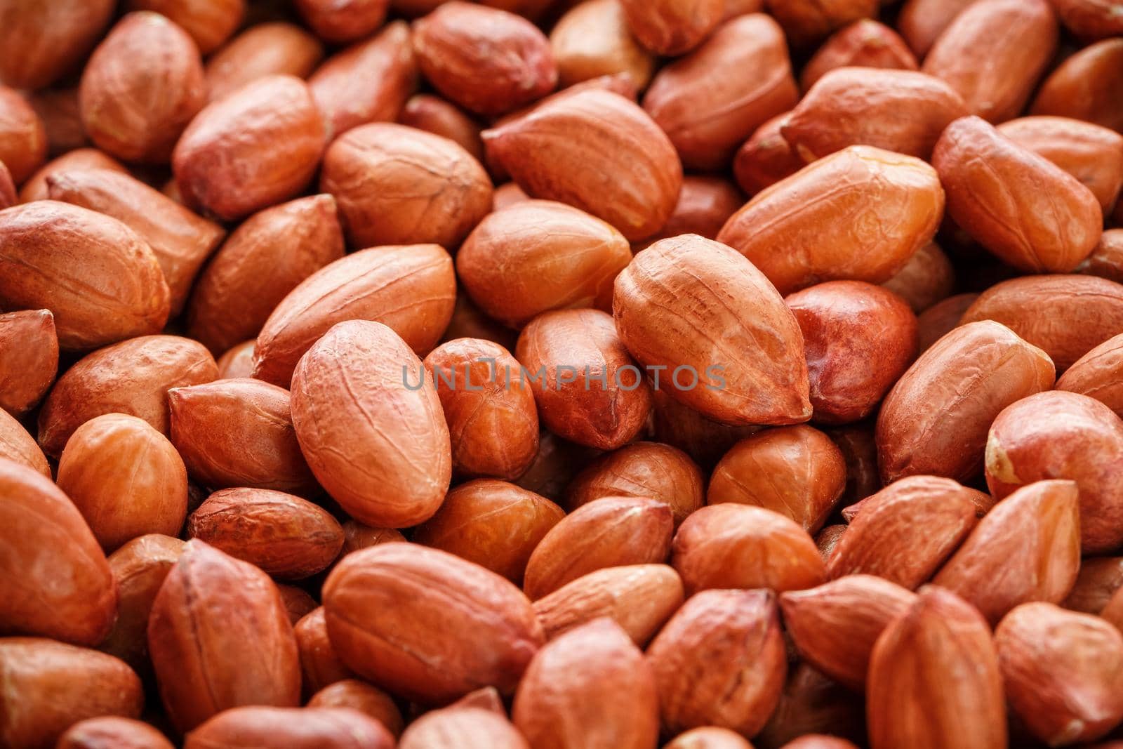 Peanuts, for background or textures, uncleaned inshell peanuts. Peeled peanut on well peanuts