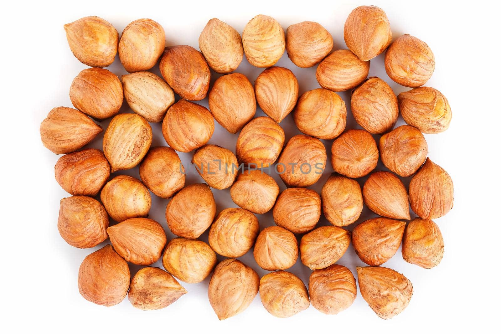 Heap of hazelnuts isolated on white background, macro image by AlexGrec