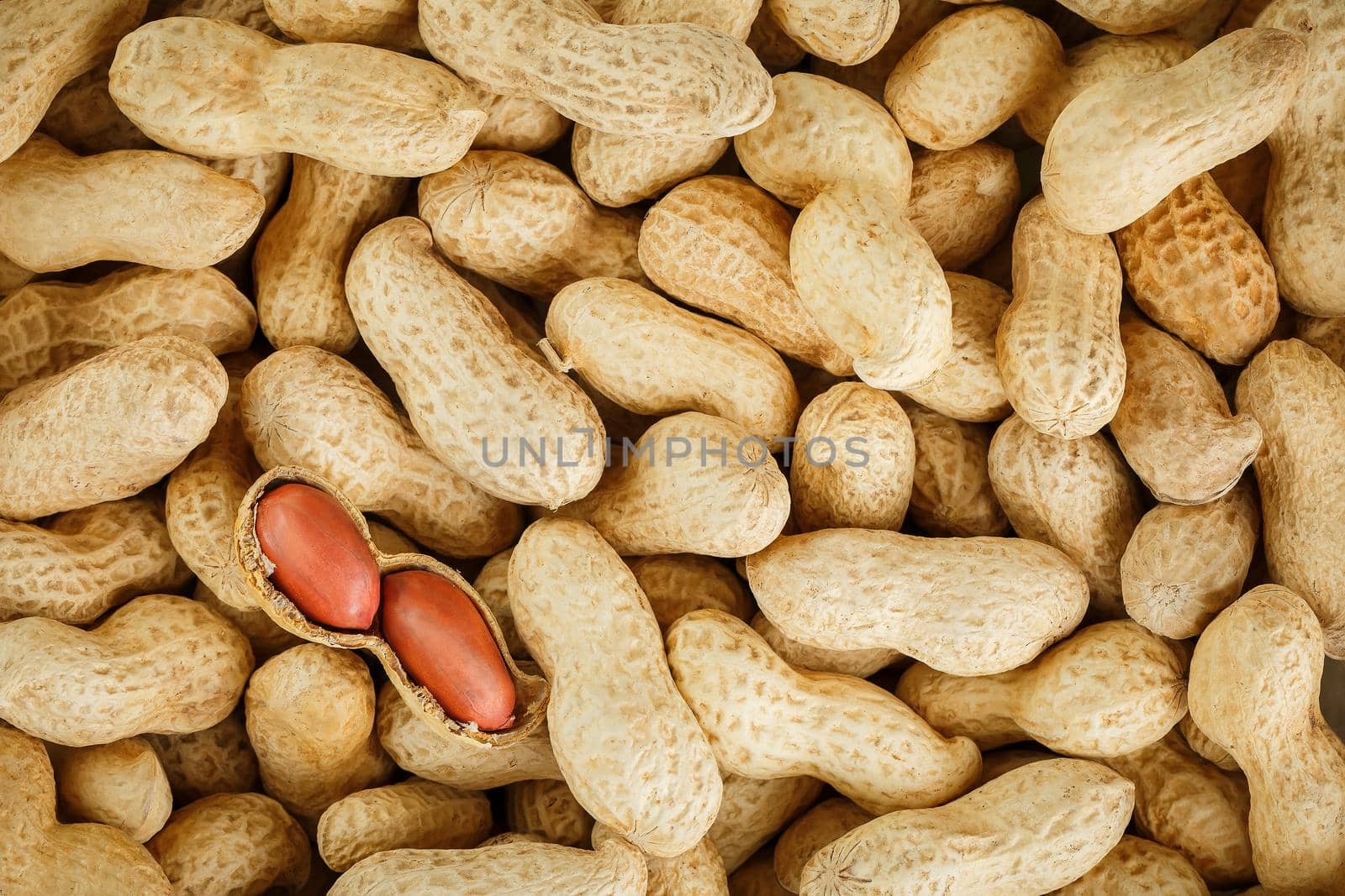 Peeled peanut on well peanuts. Peanuts, for background or textures. by AlexGrec