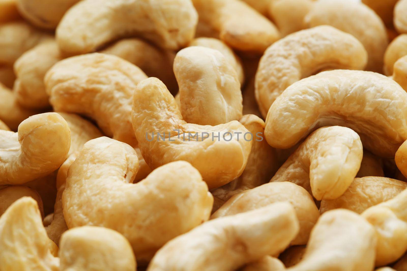 Organic cashew without shell on the background. Organic golden walnut closeup. Macro shot plan.