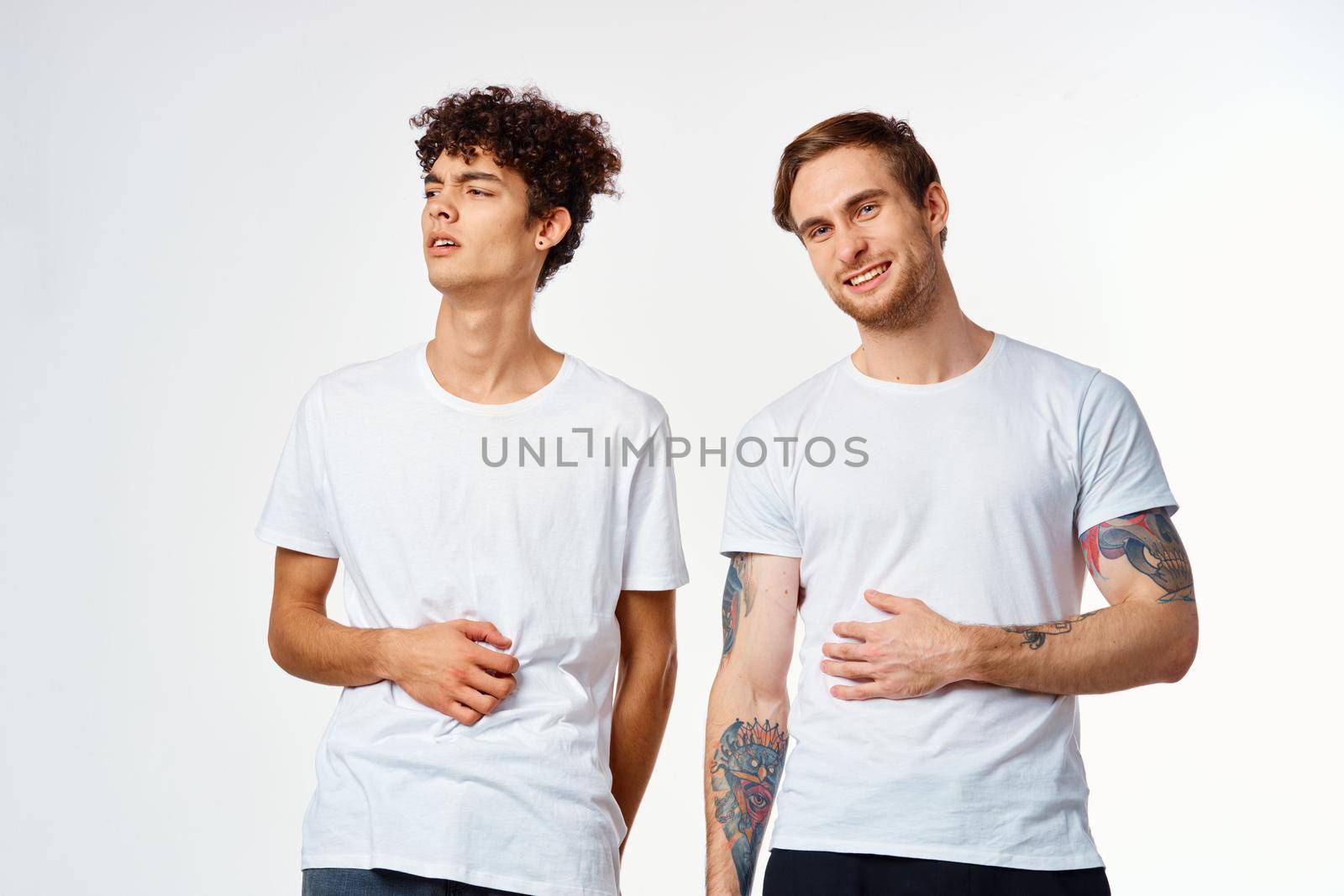 two men in t-shirts friendship communication light background. High quality photo