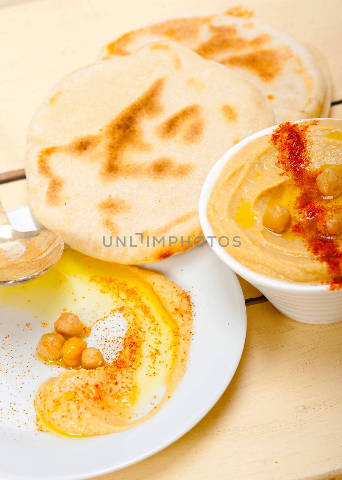 traditional chickpeas Hummus with pita bread and paprika on top 