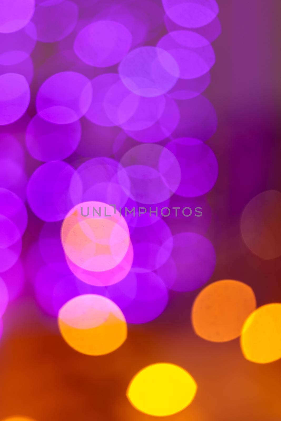 Pink bokeh on a lilac, purple background. The light is out of focus.