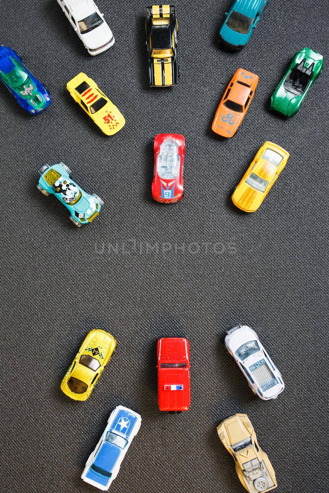 Colorful automotive toys. The apartment was lying, on a gray background.