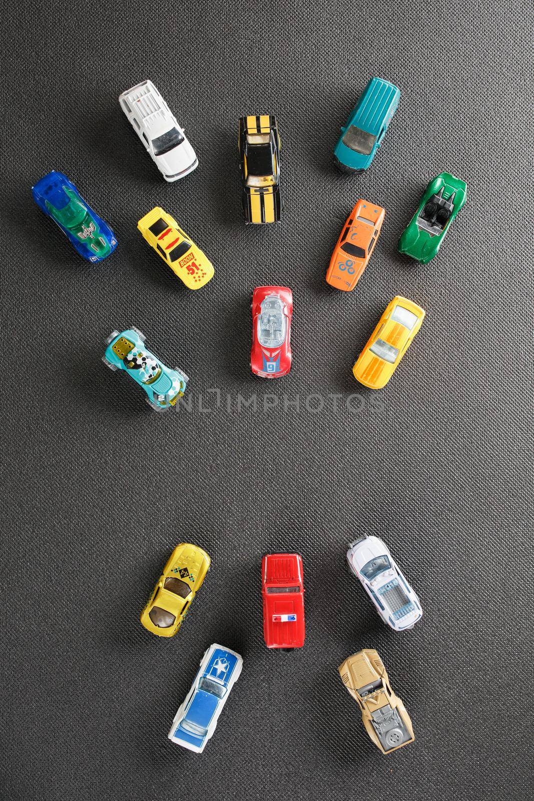 Colorful automotive toys. The apartment was lying, on a gray background.