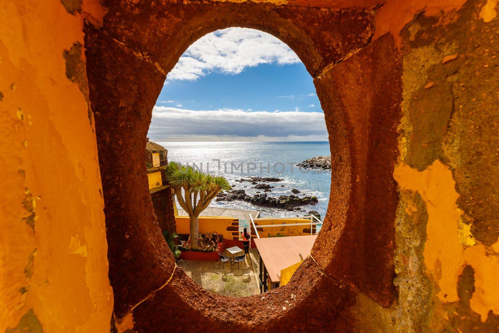 Funchal, Madeira, Portugal - December 27, 2021: view of Sao Tiago fortified castle overlooking the city and the Atlantic ocean on a winter day