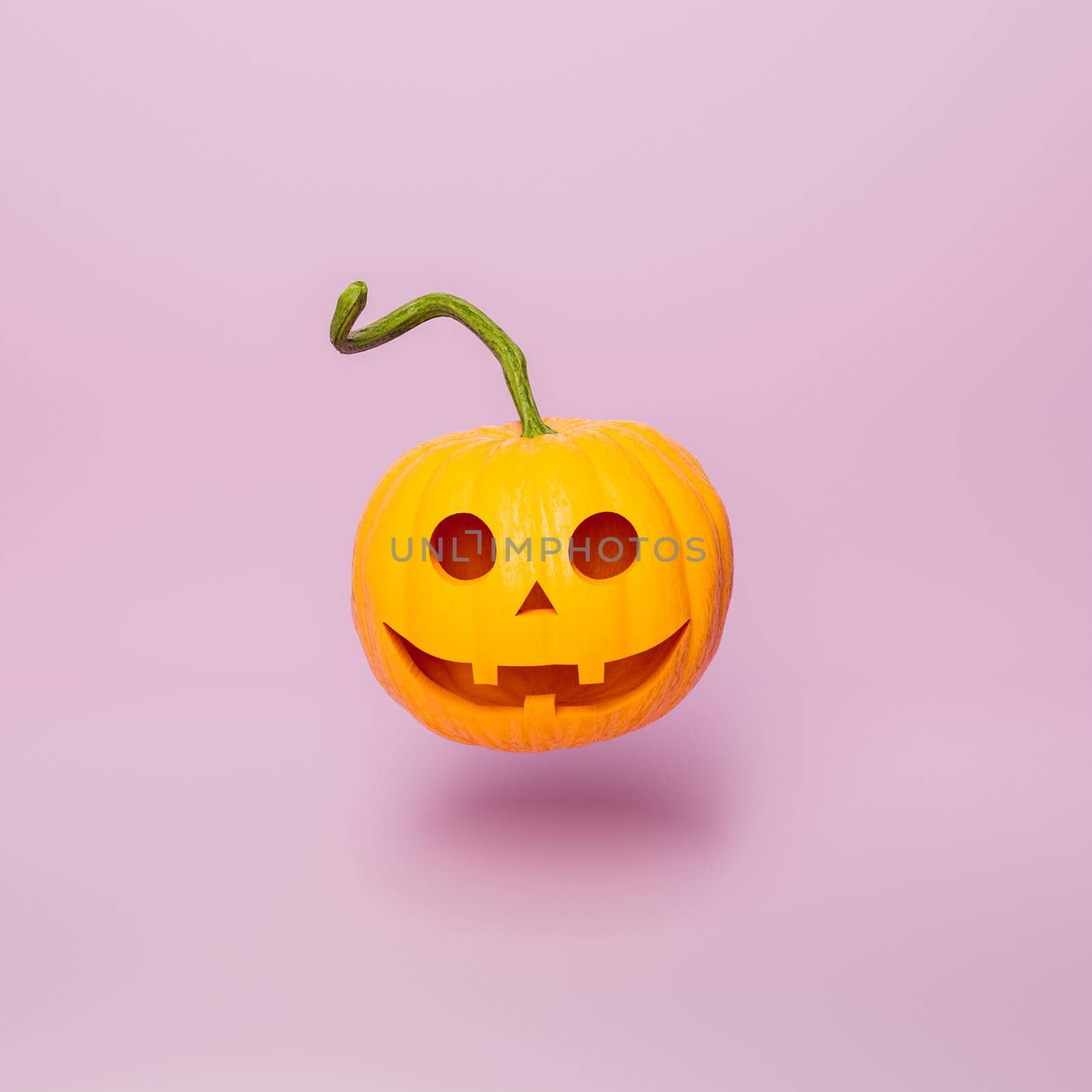 halloween pumpkin with happy face on minimal pink background by asolano