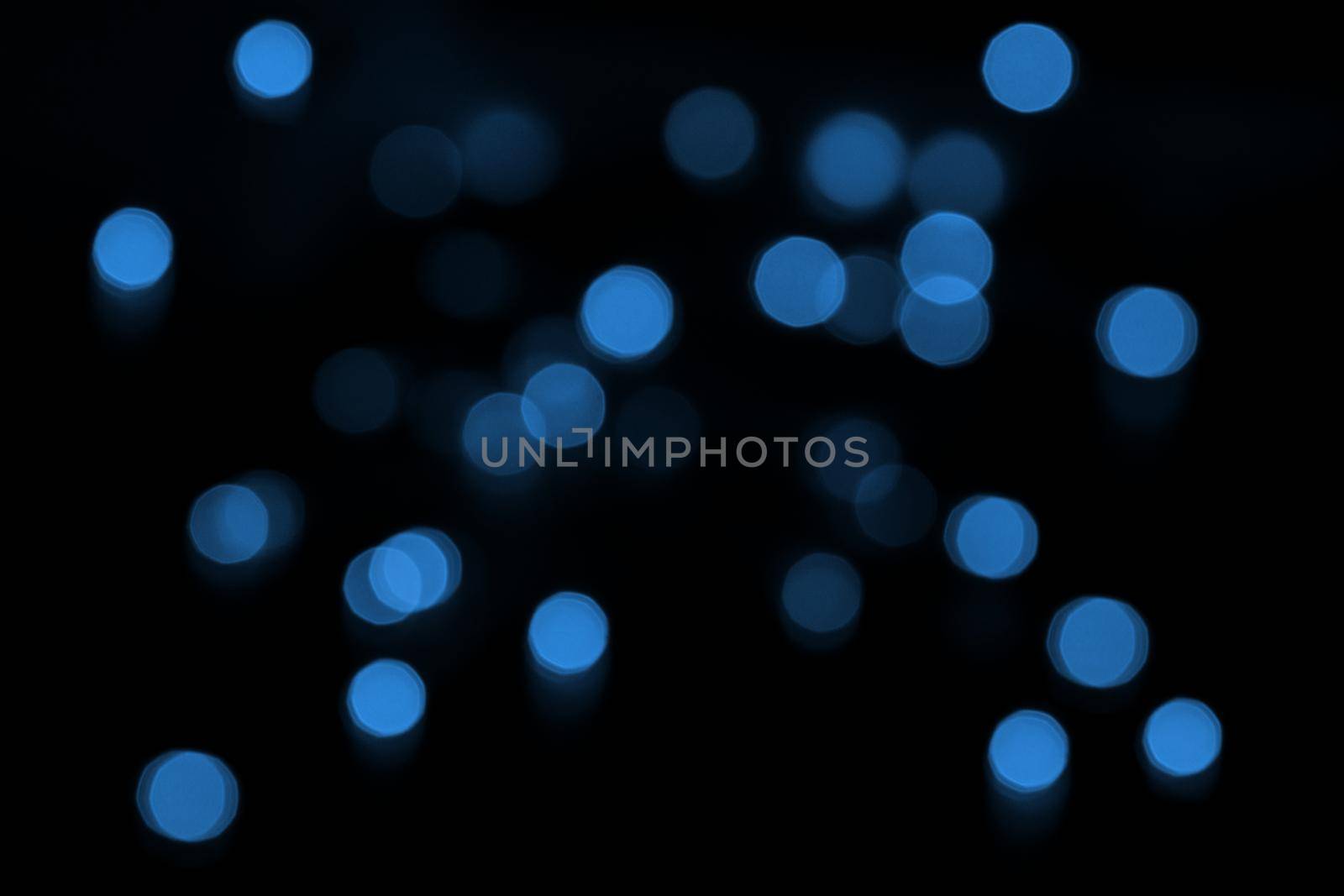 Defocused bokeh lights on black background, an abstract naturally blurred backdrop by lavsketch