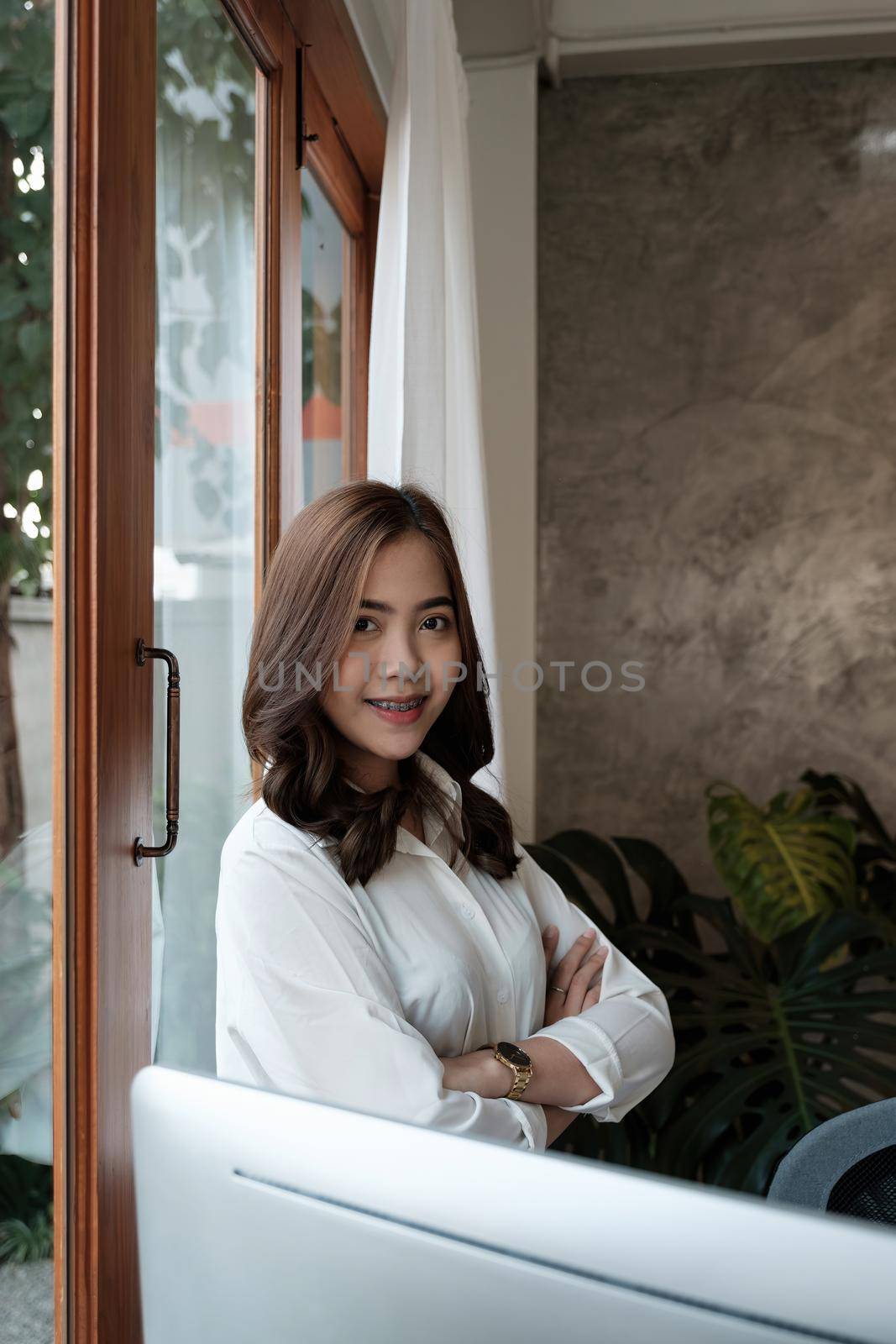Portrait of entrepreneur young asian woman, business woman arms crossed on modern office.