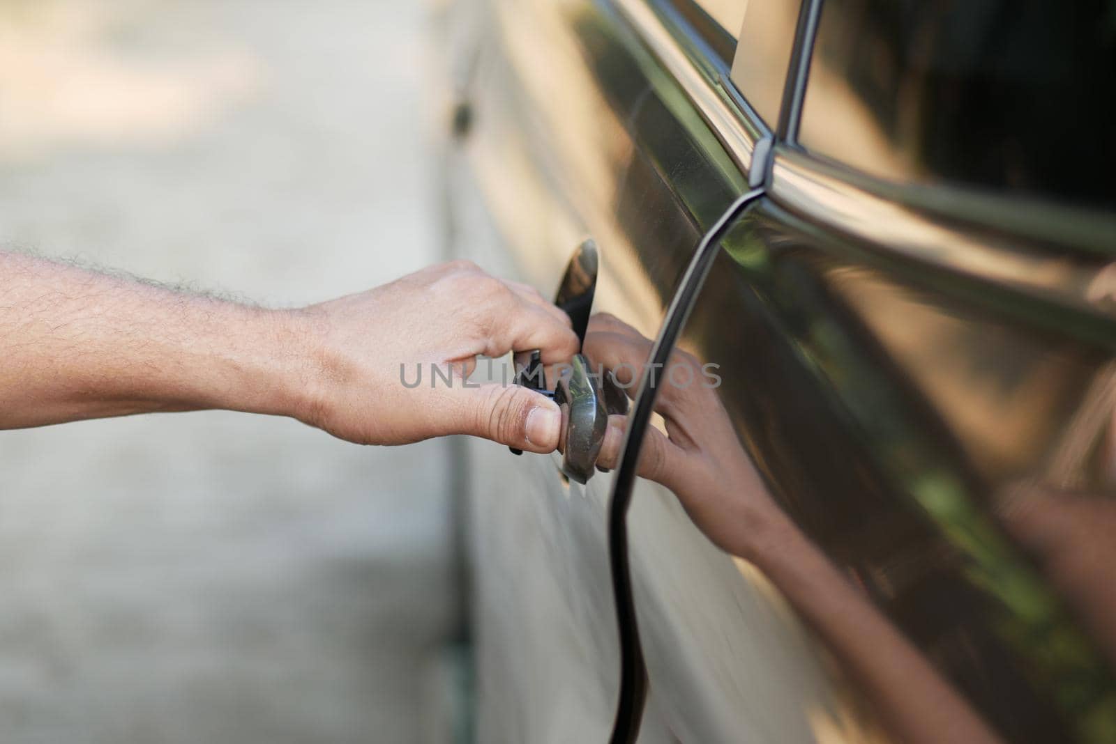 men hand open a car door .