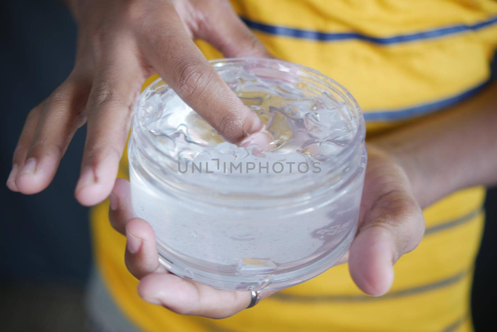 hand hold a jar of hair gel