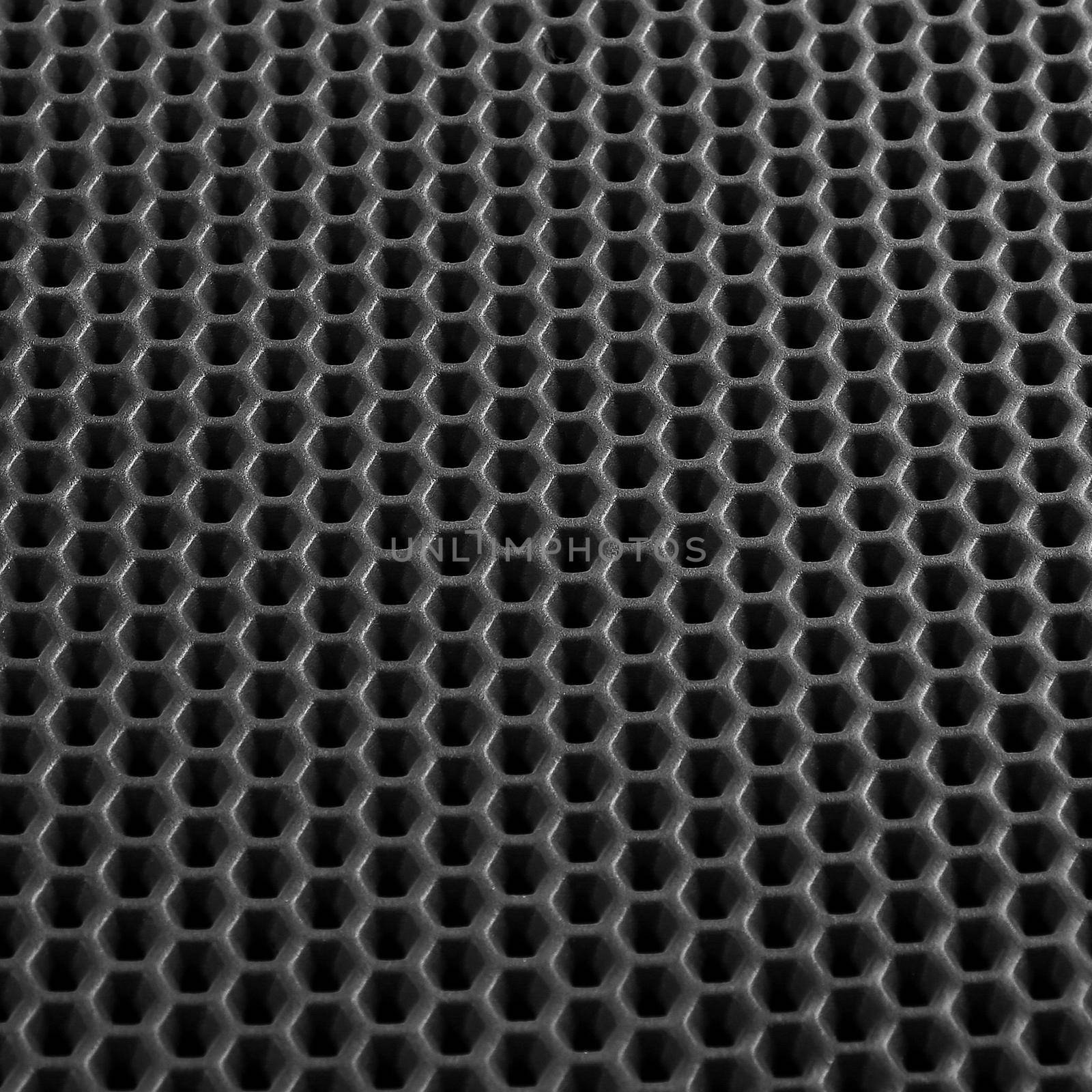 Texture of black leather background with honeycomb shape pattern, macro