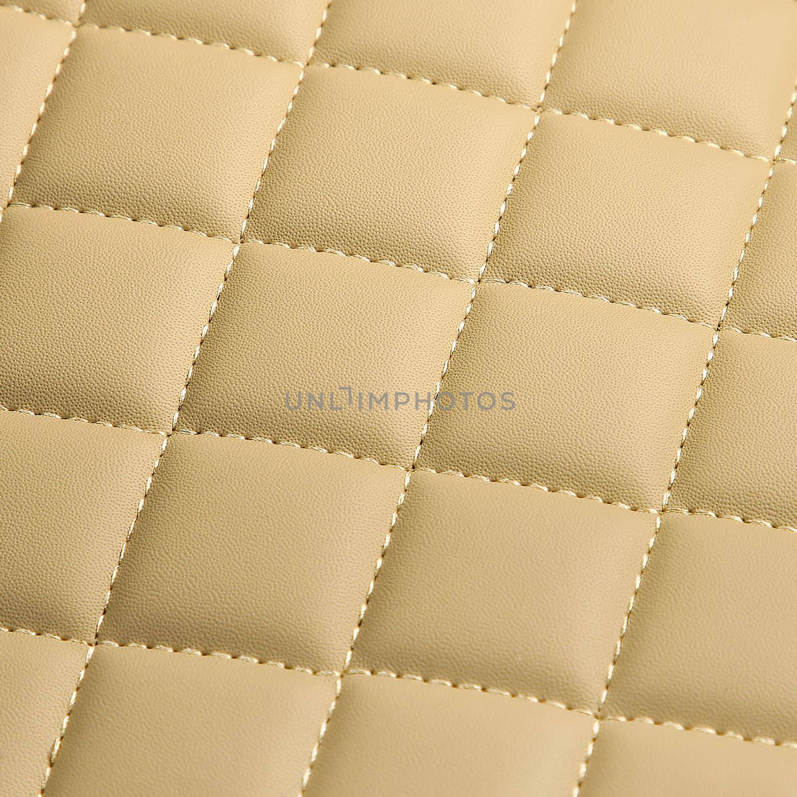 Texture of beige leather background with square pattern and stitch, macro