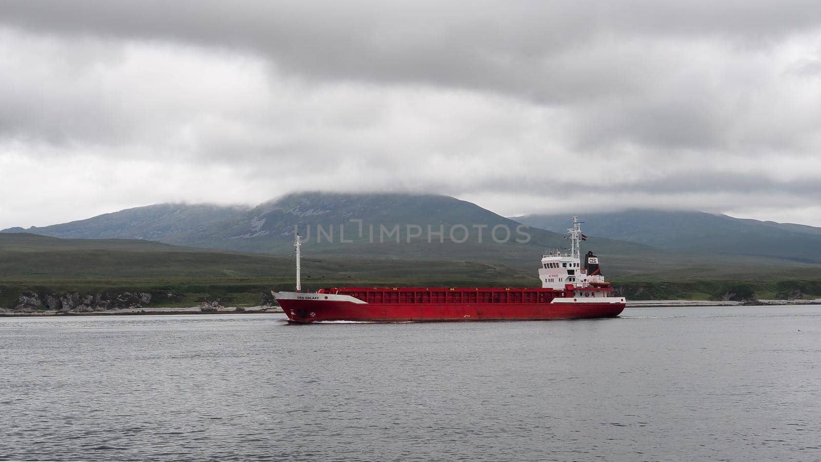 Cargo ship CEG Galaxy sailing northwards between the islands of Islay and Jura by PhilHarland