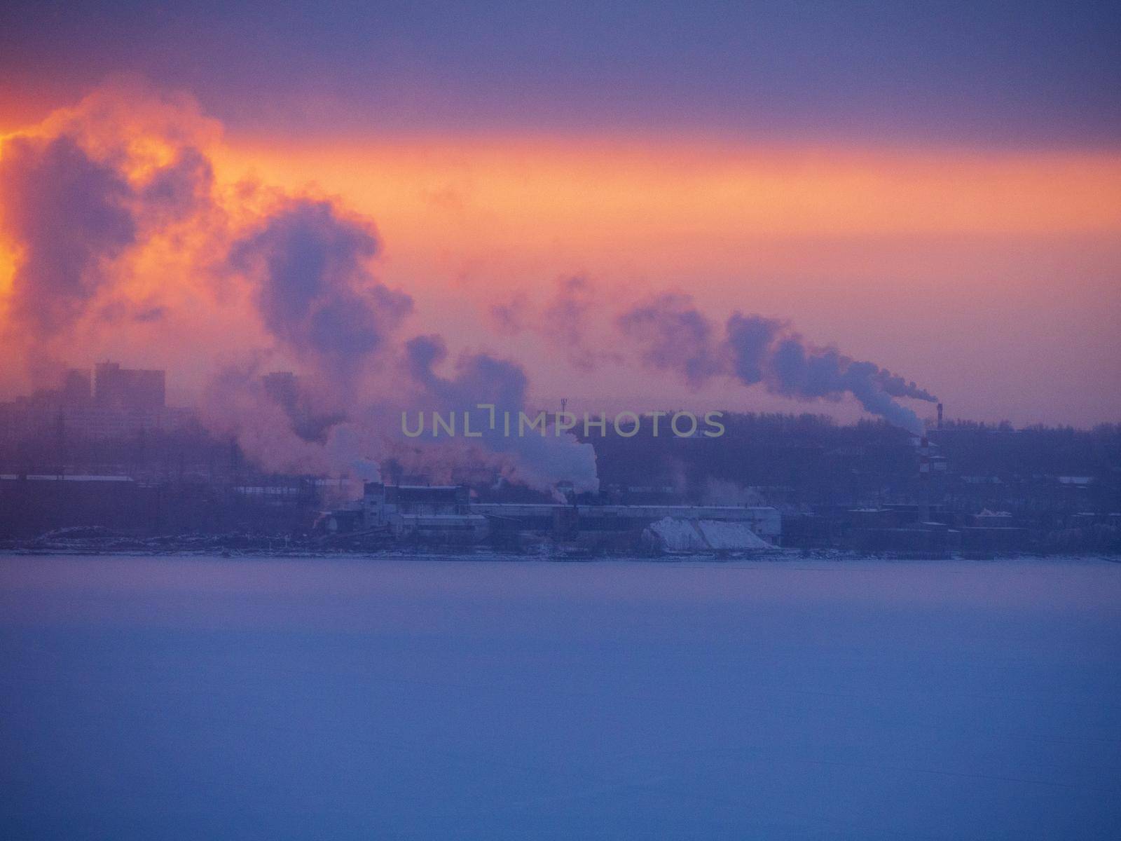 Chimneys smoke in winter against the background of the city and the sky. by Andre1ns