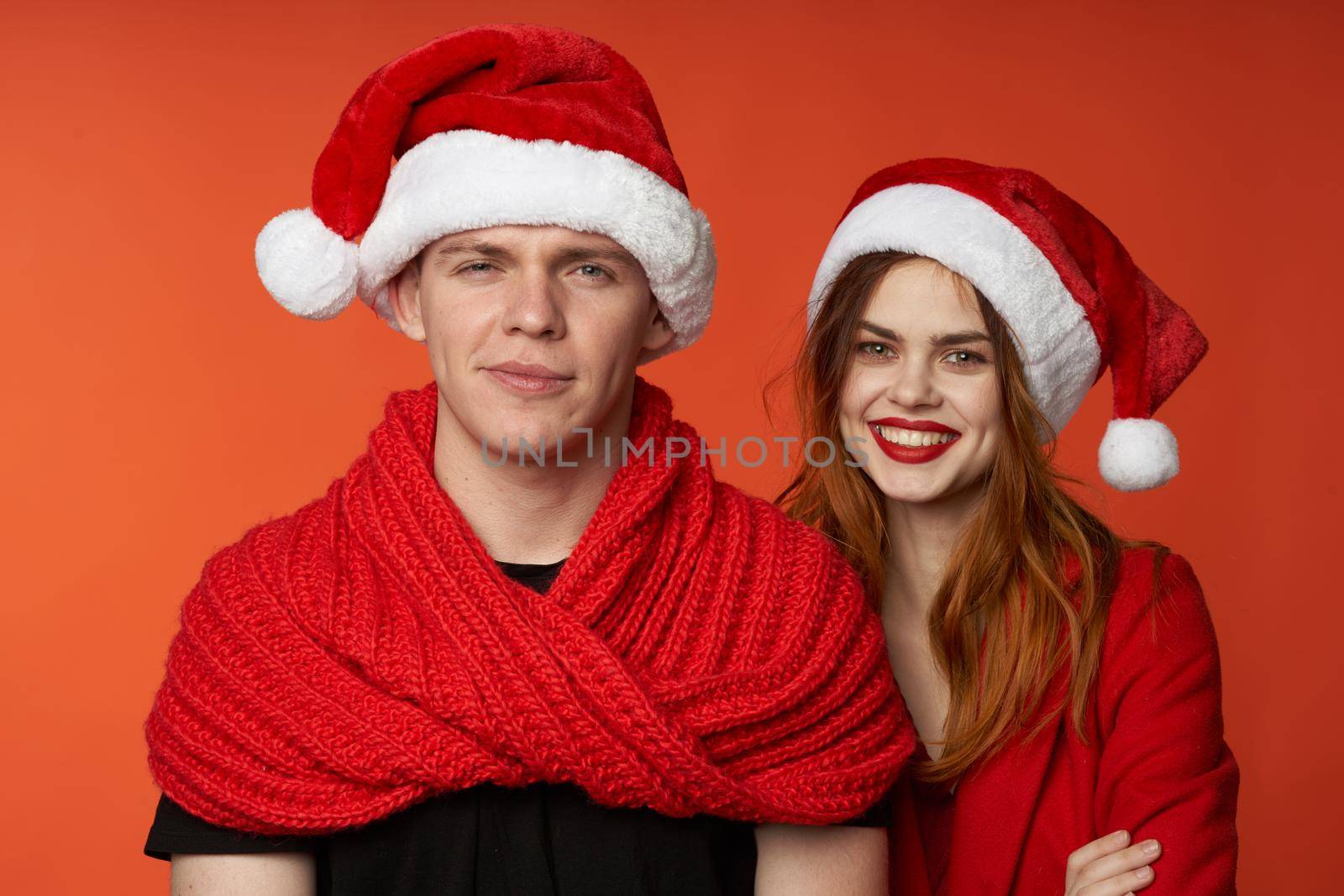 family in santa hats fun new year holiday red background by SHOTPRIME