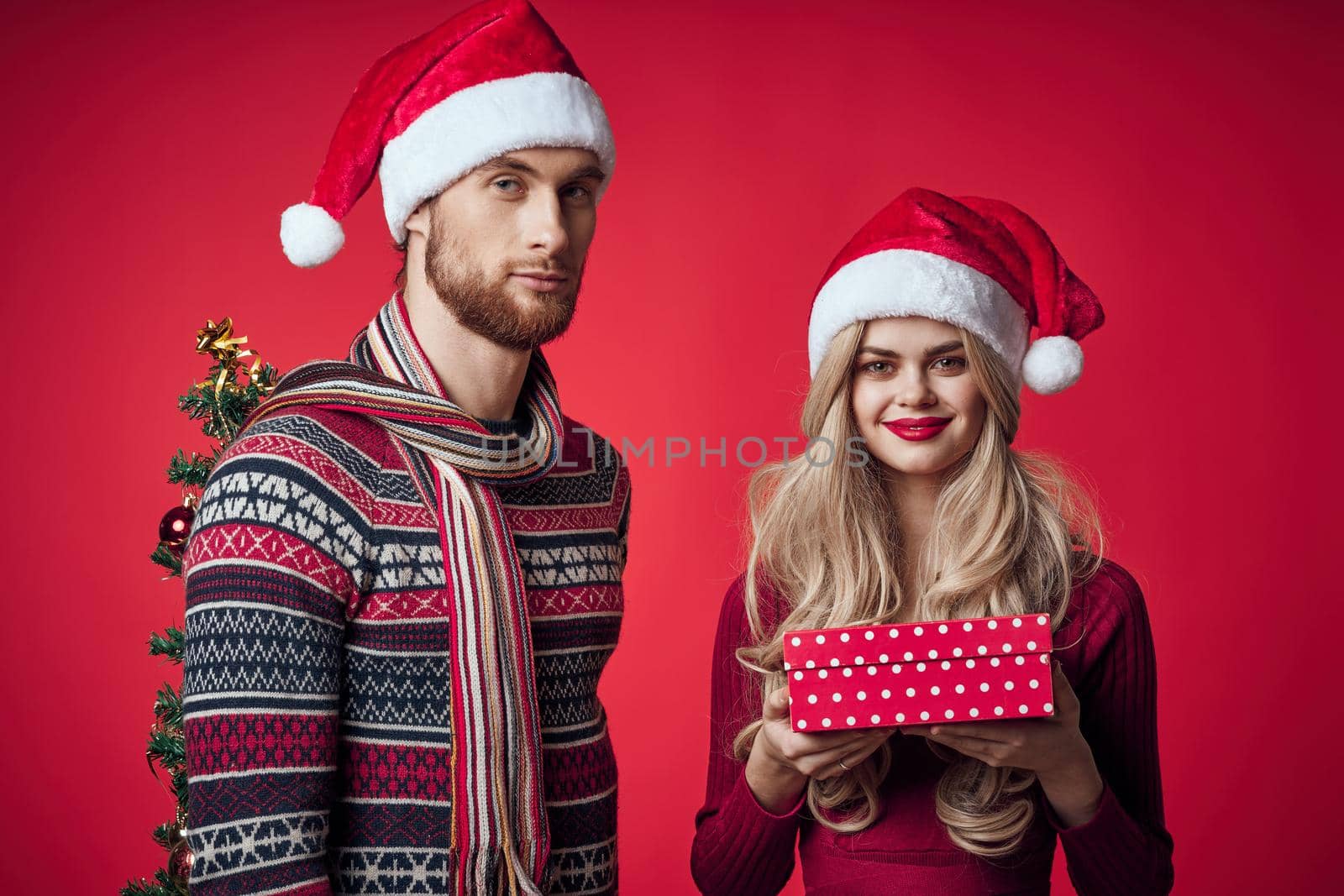 happy married couple christmas holiday decoration gifts red background. High quality photo