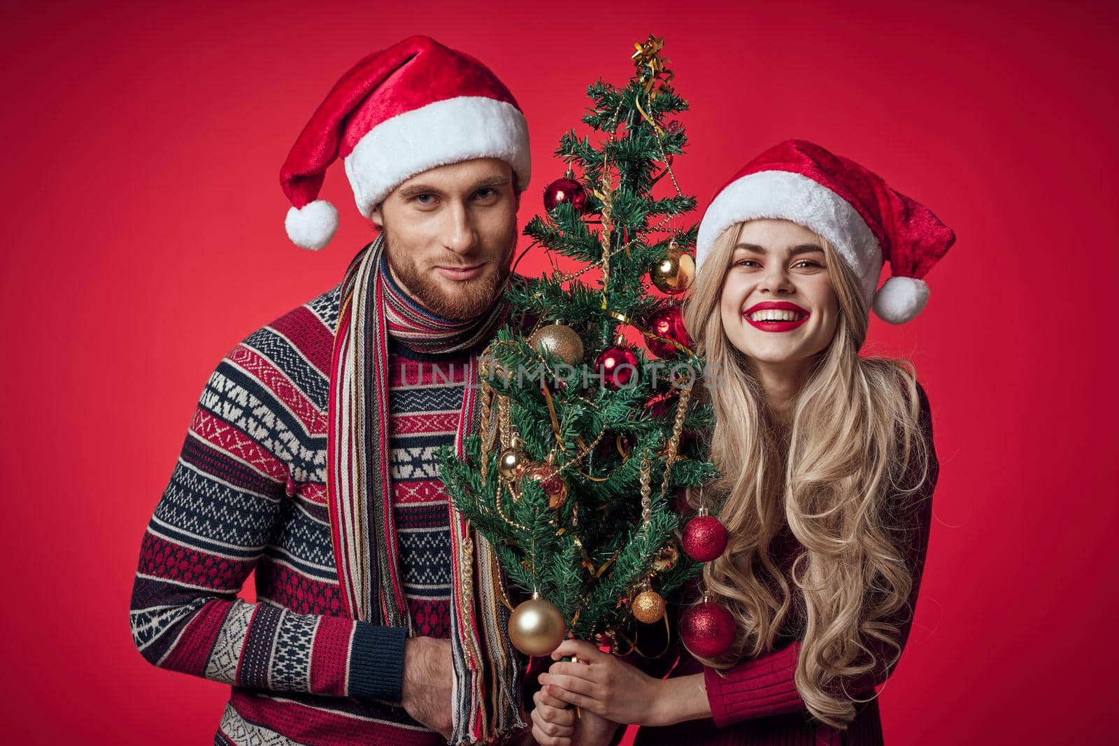 cute married couple in new year clothes holiday christmas studio. High quality photo