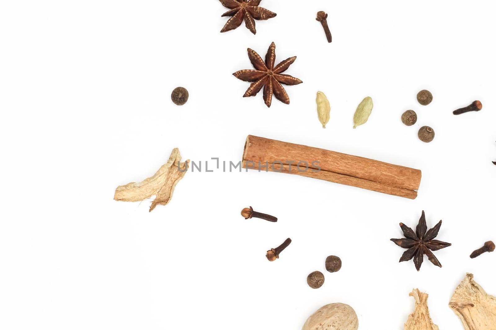 Mulled wine set. A set of spices for mulled wine on a white background. Raisins, ginger, cinnamon, star anise, cardamom, cloves top view on a white background. Hot medicinal drink. Winter cocktail.