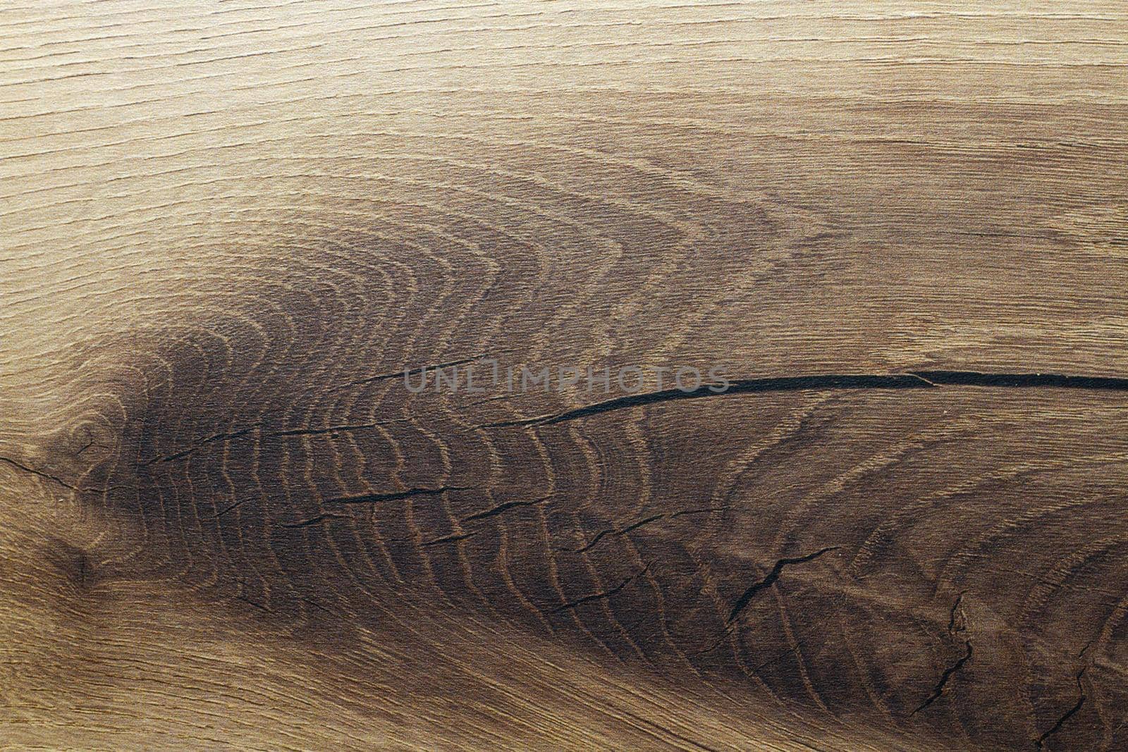 Wood texture. Wooden board close up. The cracks are deep. Laminate flooring. Tree rings in a cut.