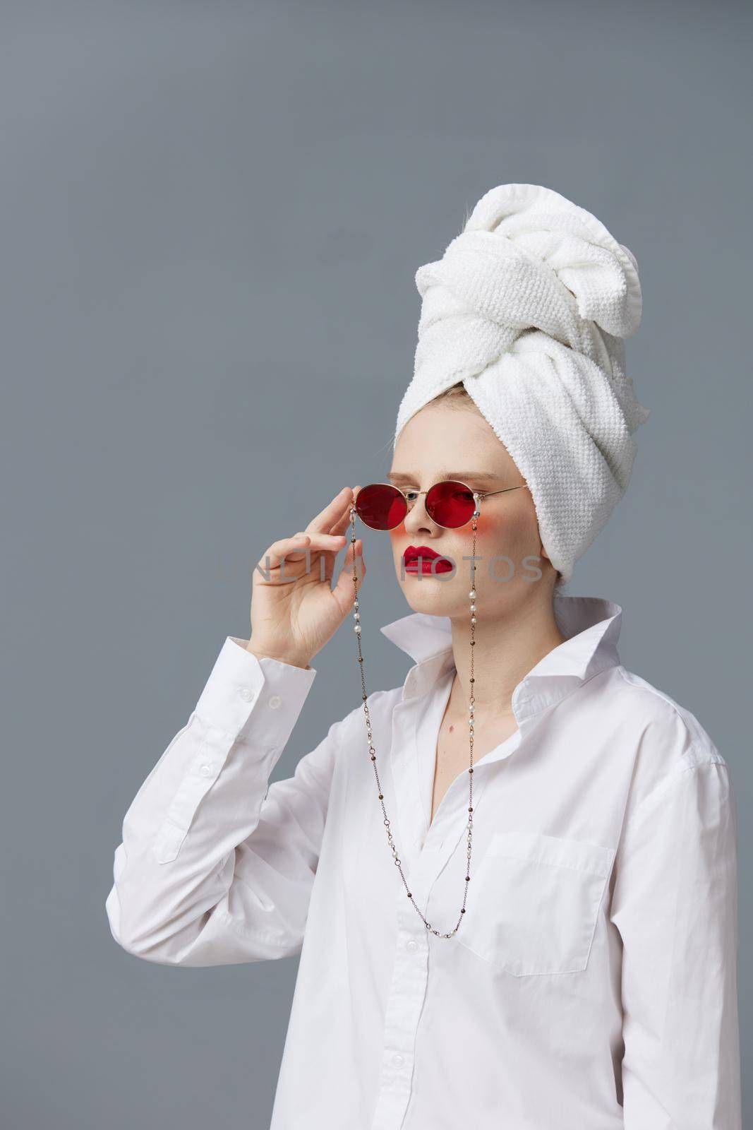 portrait of a woman with a towel on his head in a white shirt isolated background by SHOTPRIME