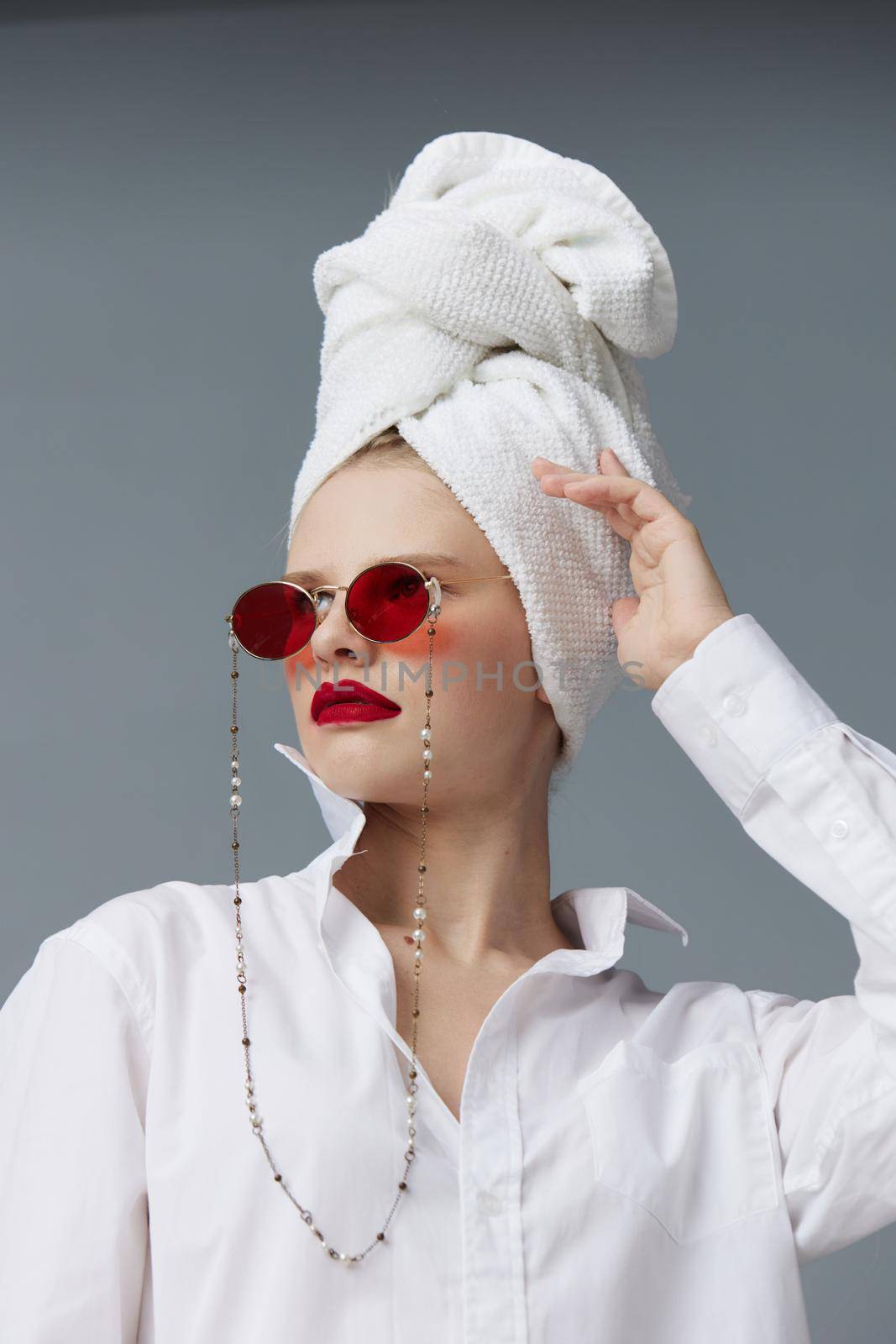 glamorous woman red sunglasses cosmetics with towel on head isolated background. High quality photo