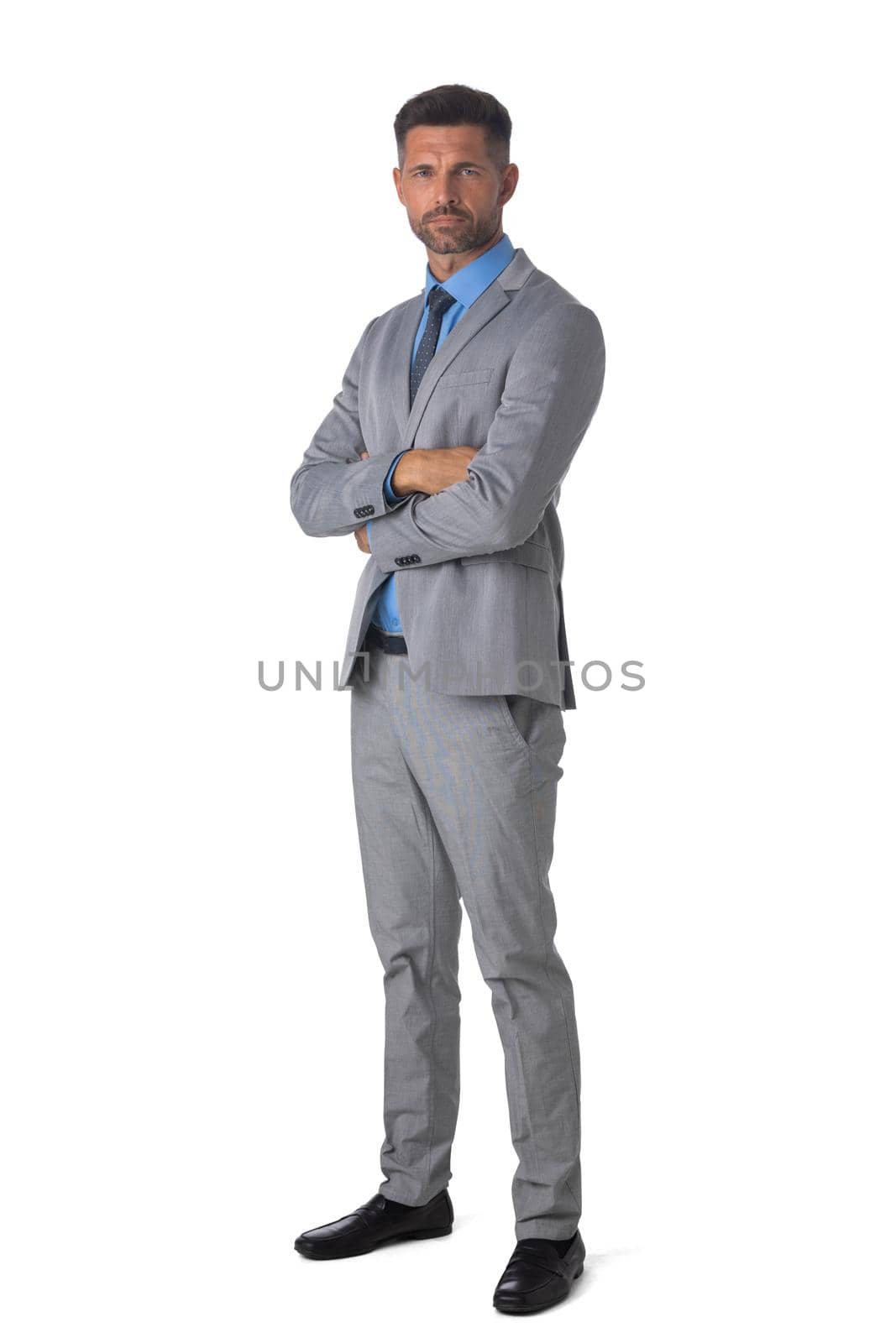 Portrait of handsome businessman standing with arms crossed isolated on white background