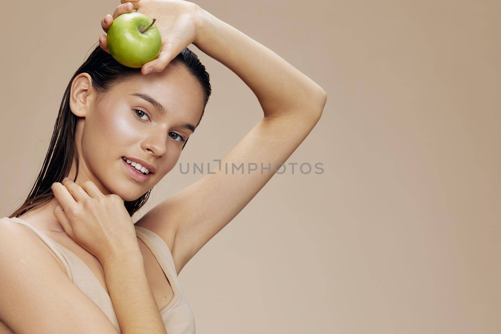 woman green apple near face health close-up Lifestyle. High quality photo