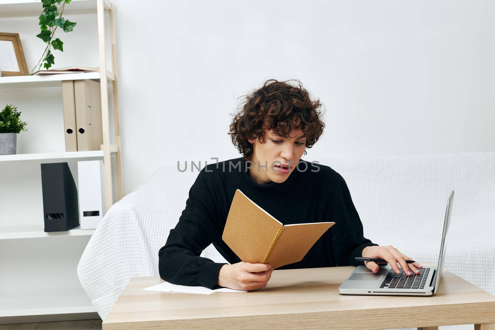 man laptop sitting on white sofa online training living room. High quality photo