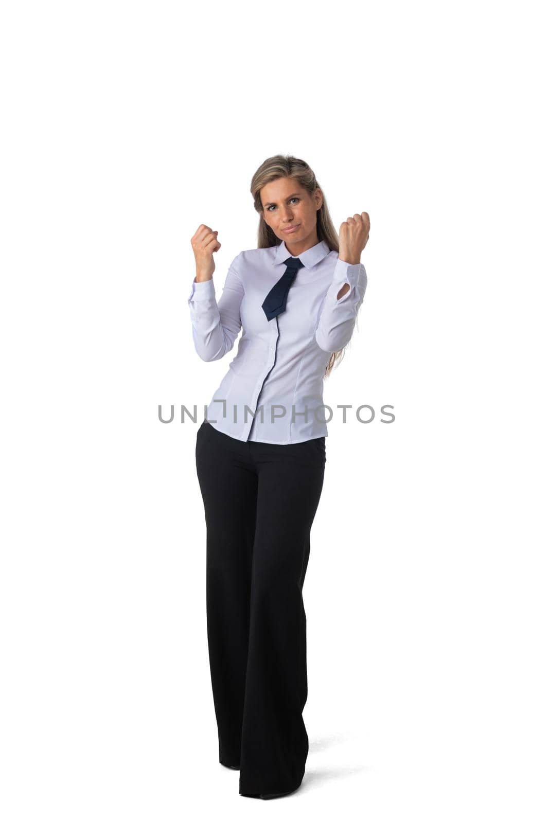 Happy smart business woman in suit smiling, holding hands in the air and celebrating, walking isolated on white background in studio